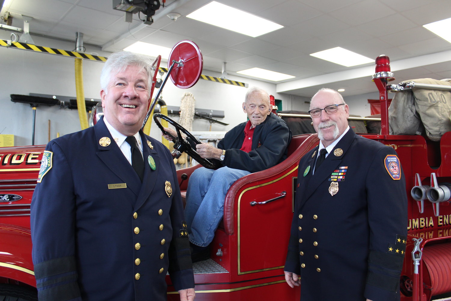 An ecstatic Karl Thuge sat at the driver’s wheel of the historic 1947 Mack truck that he and members of the Columbia Engine Company No. 1 Historical Committee — including Bill Lynch, left, and Fredrick Robinson — sought. Thuge worked in the same factory in which the truck was built in 1947.