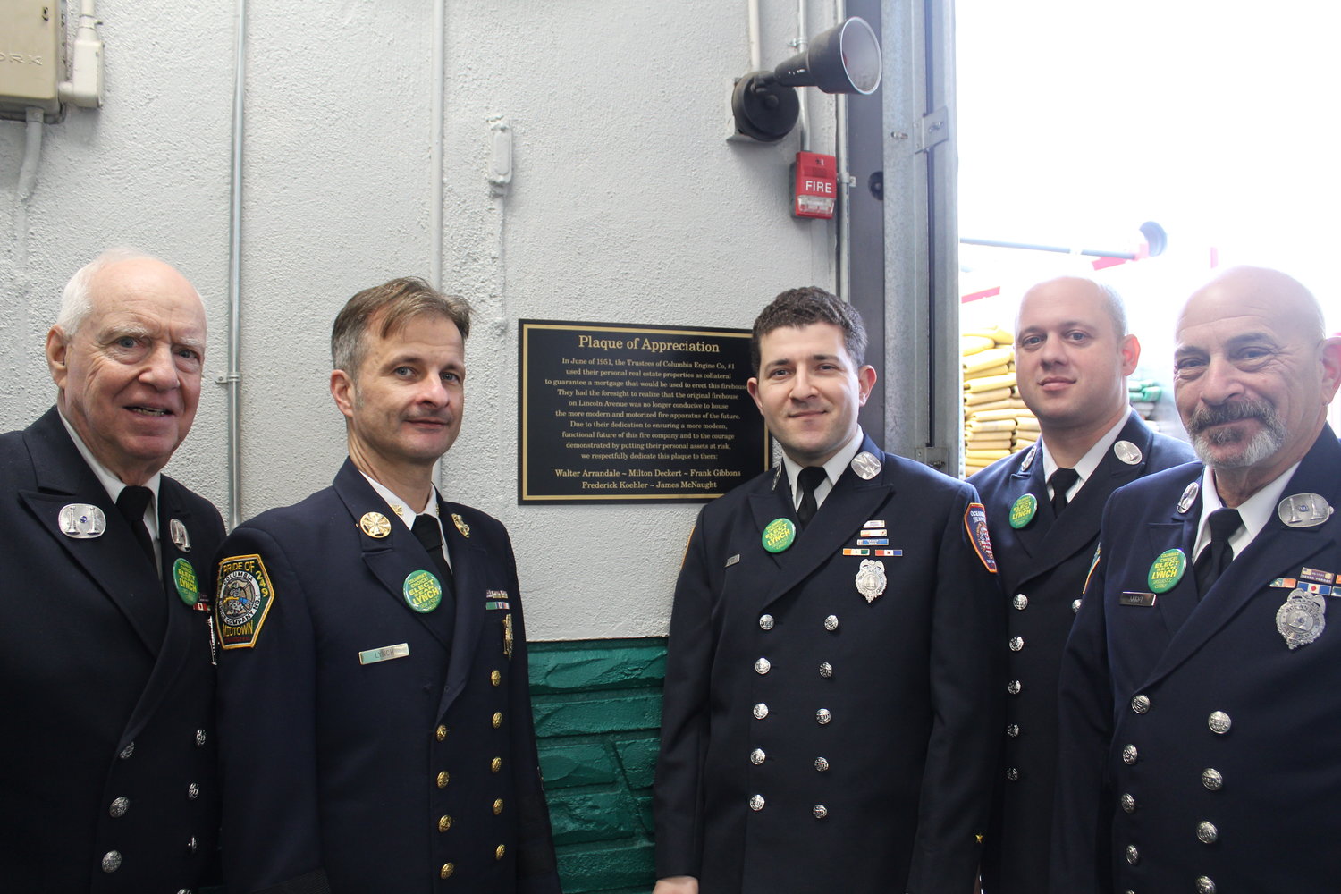 Members of the Oceanside Columbia Engine Company No. 1 historical committee in front of their new Plaque of Appreciation for the five members who, in 1951, mortgaged their houses to build the fire station.
