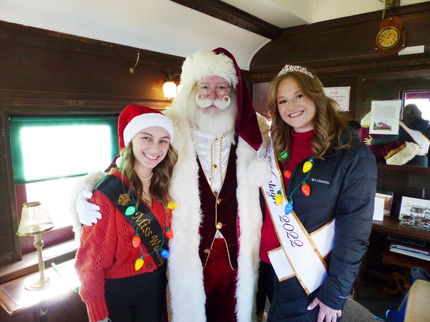 Santa Claus greeted children aboard the Preservation Society’s parlor car, with help from Miss Wantagh, Lilly Sloves, right, and Faith Stallone, a member of her court.