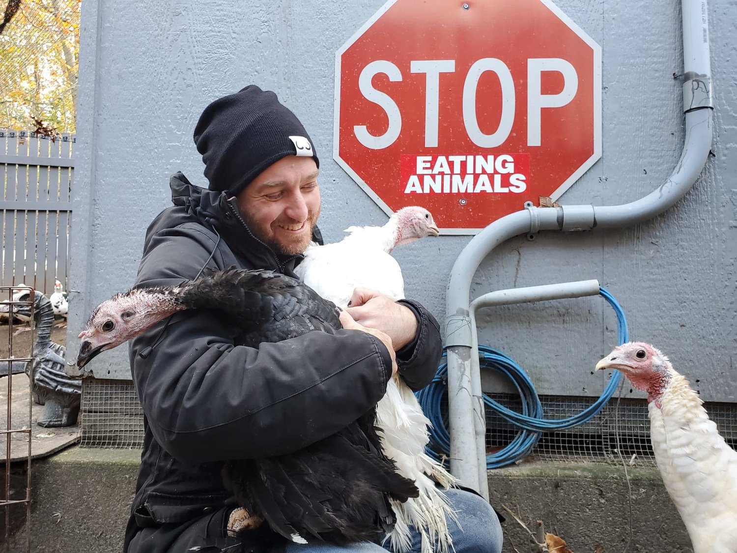 Humane Long Island founder John Di Leonardo embracing the rescued turkeys