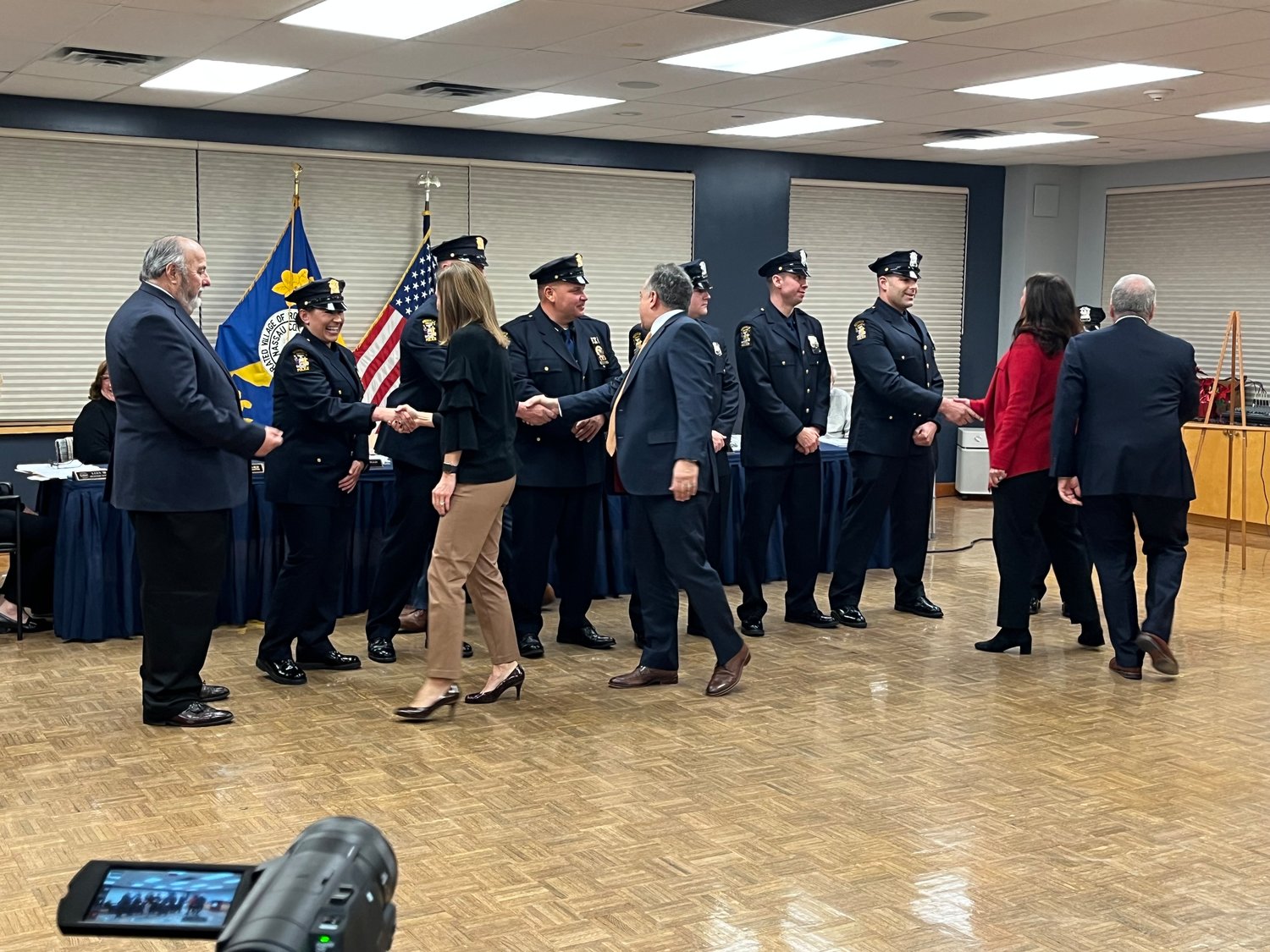 Village officials congratulate new officers on their appointment.