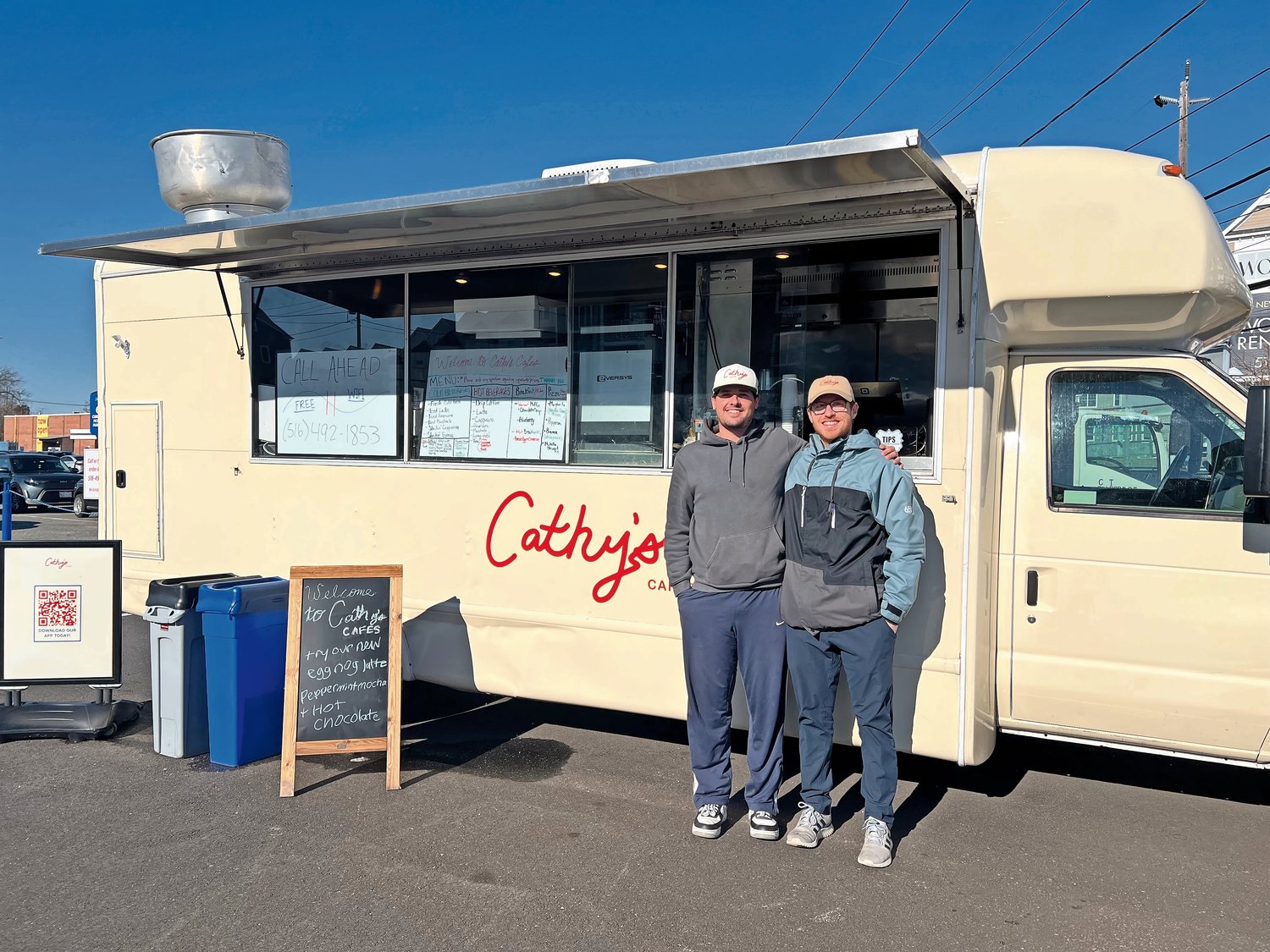 Tom Turner, left, and Matthew Gonyon, right, standing in front of their coffee truck business, Cathy’s Cafes.