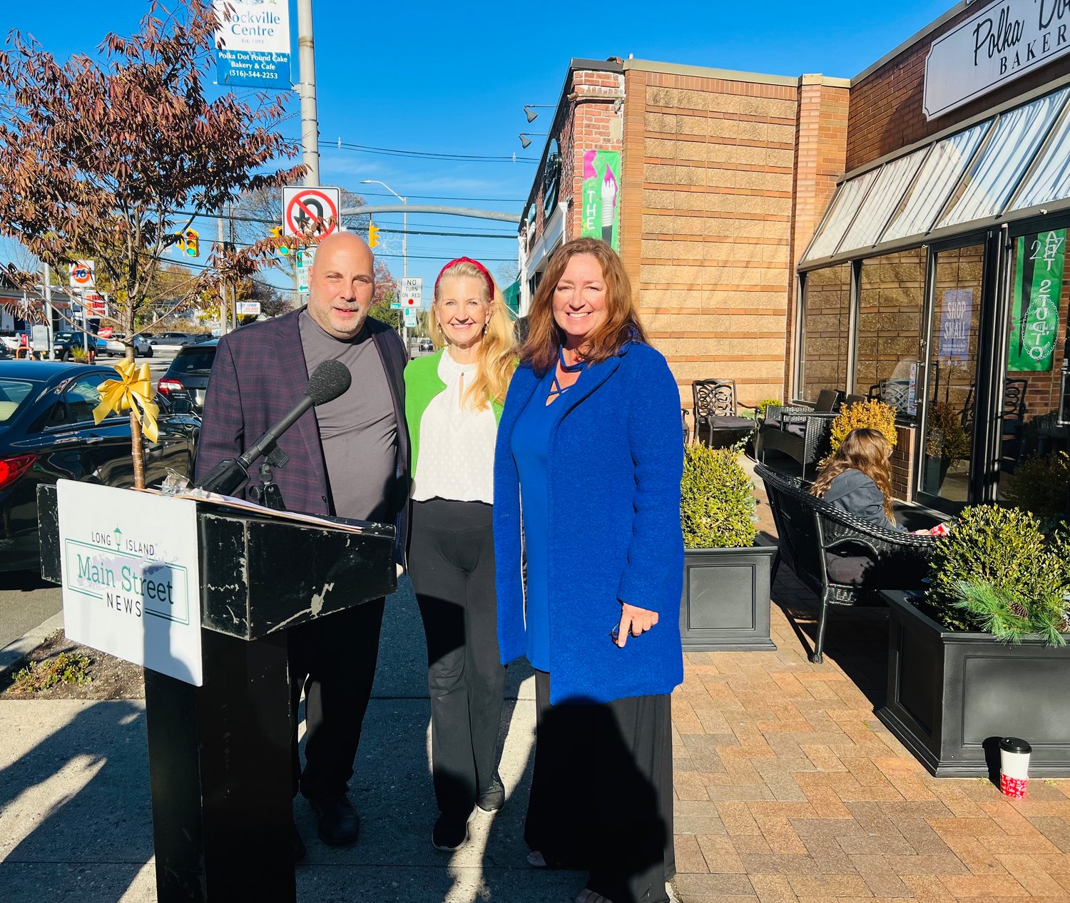 Eric Alexander, president of Vision Long Island, Lisa Unmansky, president of the Rockville Centre Chamber of Commerce and Lisa Dellipizzi support shopping local.