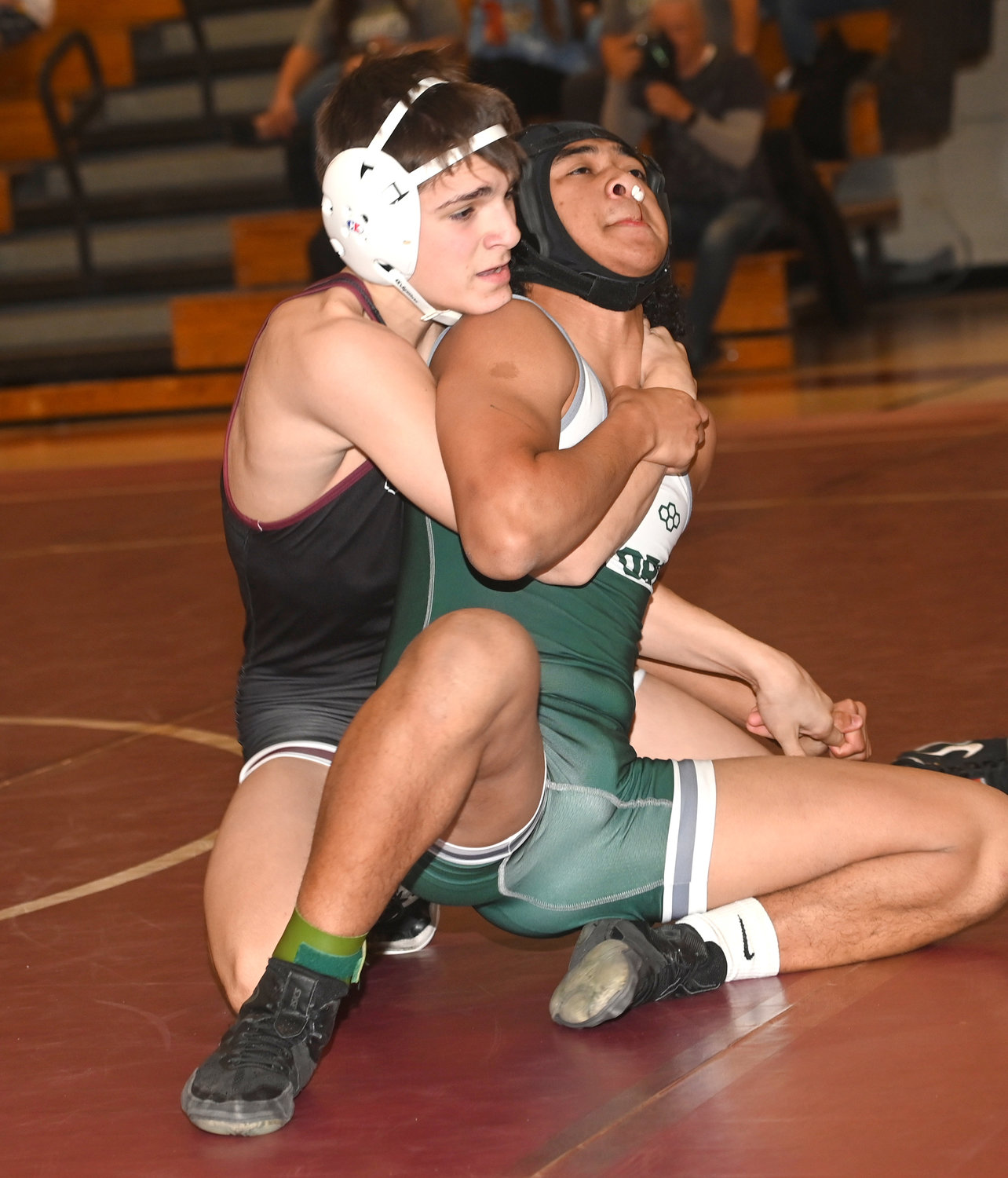 North Shore sophomore Evan Giakoumas, left, opened the season with five straight victories in the 152-pound weight class.