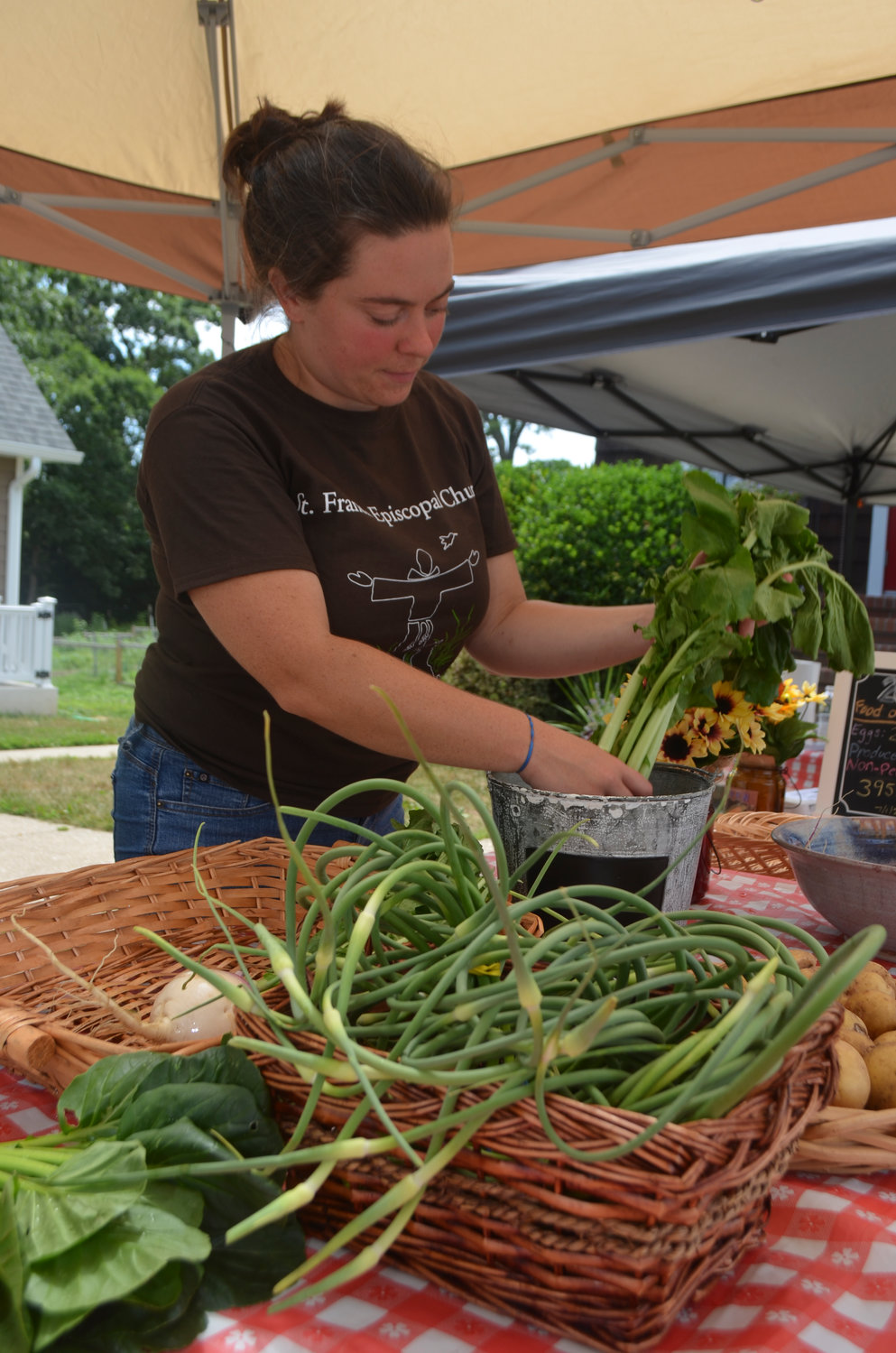 Kristin Talbot, the garden and office manager at St. Francis Episcopal Church in North Bellmore, tended to some crops at a farm stand this summer.