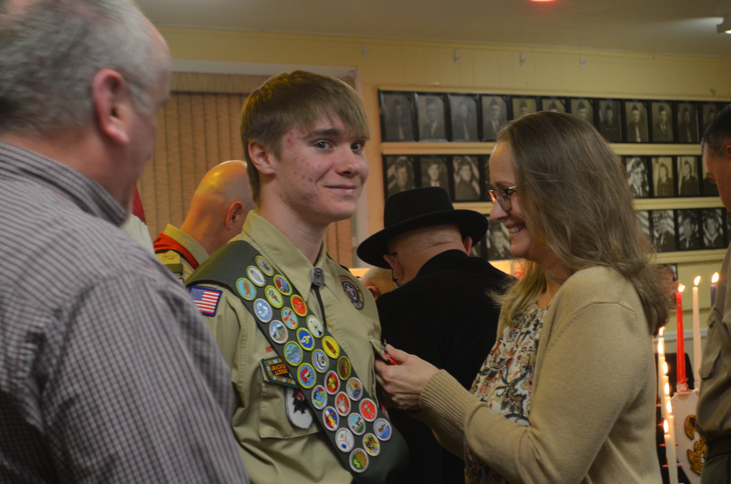 Ryan Noonan got a helping hand from his proud mother, Amy, who pinned on his Eagle Scout badge.