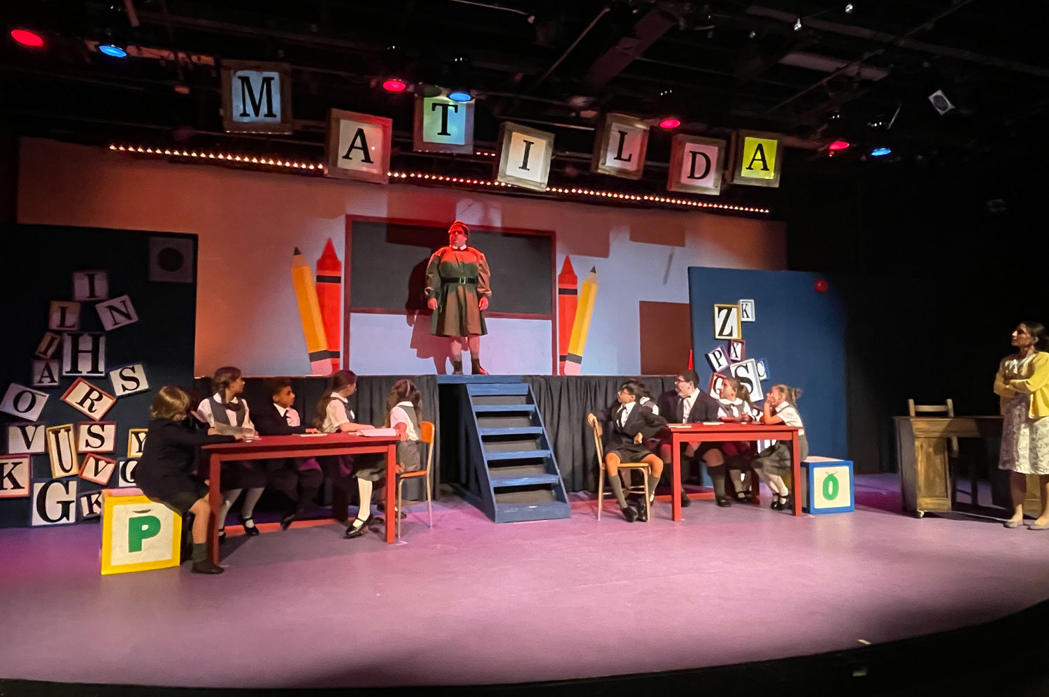 At a key moment in ‘Matilda,’ at the Merrick Theatre & Center for the Arts, the intense Miss Trunchbull, played by Jay Braiman, enters the classroom.