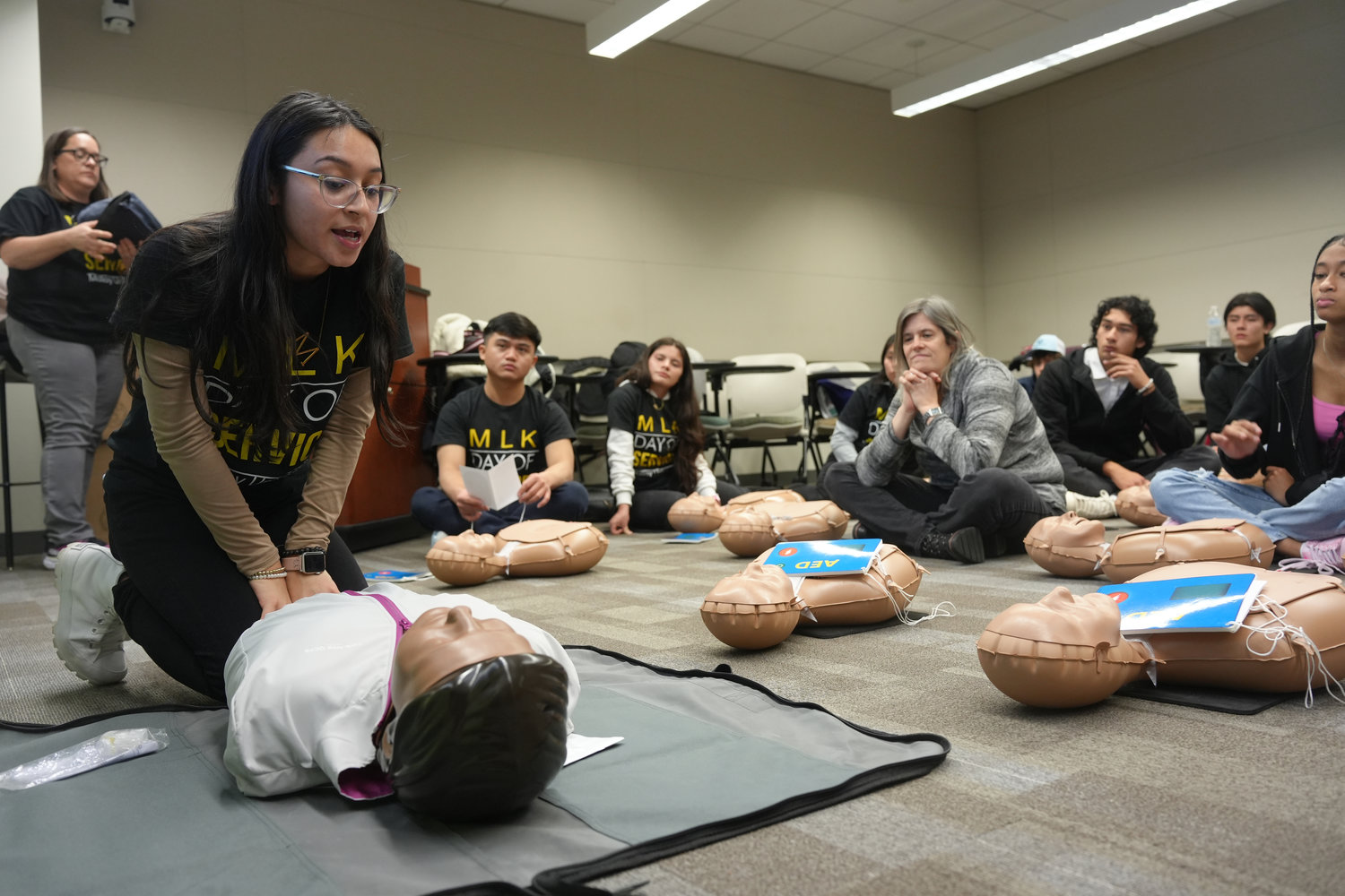 Nursing student Melissa Jaco instructs the class on how to correctly perform CPR, during the MLK Day of Service event at Molloy University.