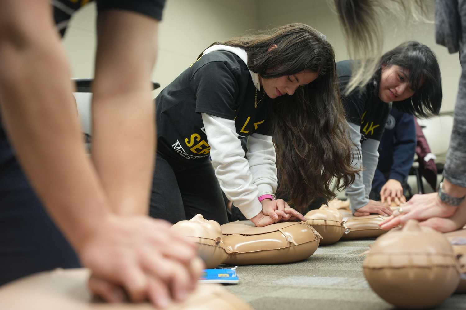 Molloy University, in Rockville Centre, celebrated the fifth annual MLK Day of Service with a series of workshops. During the CPR training lesson, students Evelyn Fernandez and Natalia Tapia, of Freeport, practiced chest compressions on dummies.