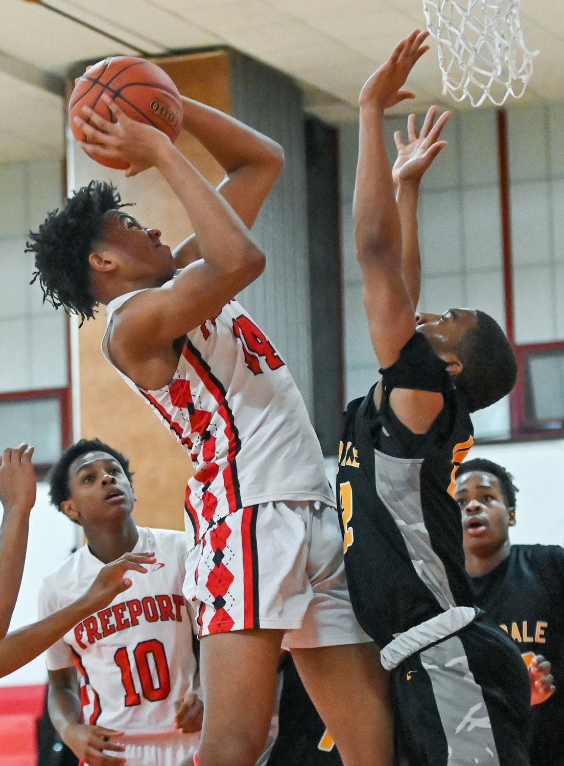 Freeport’s Elijah Darby, left, eyed the rim during the Red Devils’ hard-fought defeat to Uniondale on Tuesday evening.
