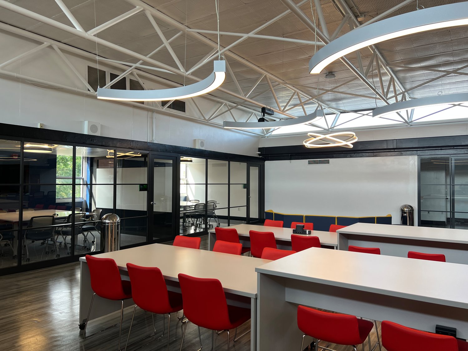 The ‘collaboratory’ is a new library and media center with contemporary furniture  on the second floor of the high school. It features five private, glass-enclosed meeting spaces, and rooms with video-conferencing equipment.
