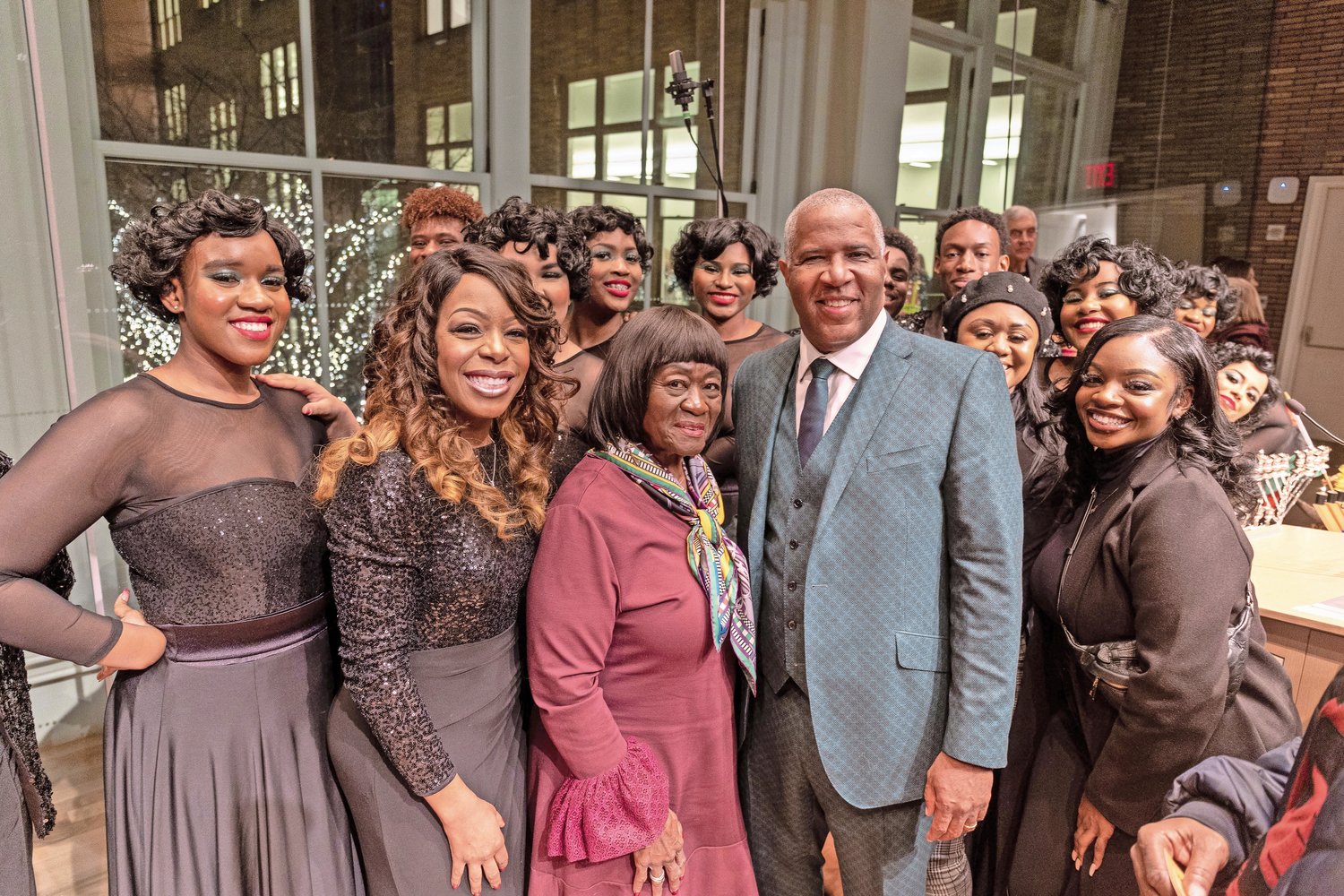 The Uniondale Show Choir surrounded director Lynnette Carr-Hicks, second from left, Deputy Supervisor Dorothy L. Goosby, third from left, philanthropist Robert F. Smith, and Show Choir choreographer Joynell Carr to celebrate the Fifteen Days of Light event at Carnegie Hall on Dec. 18