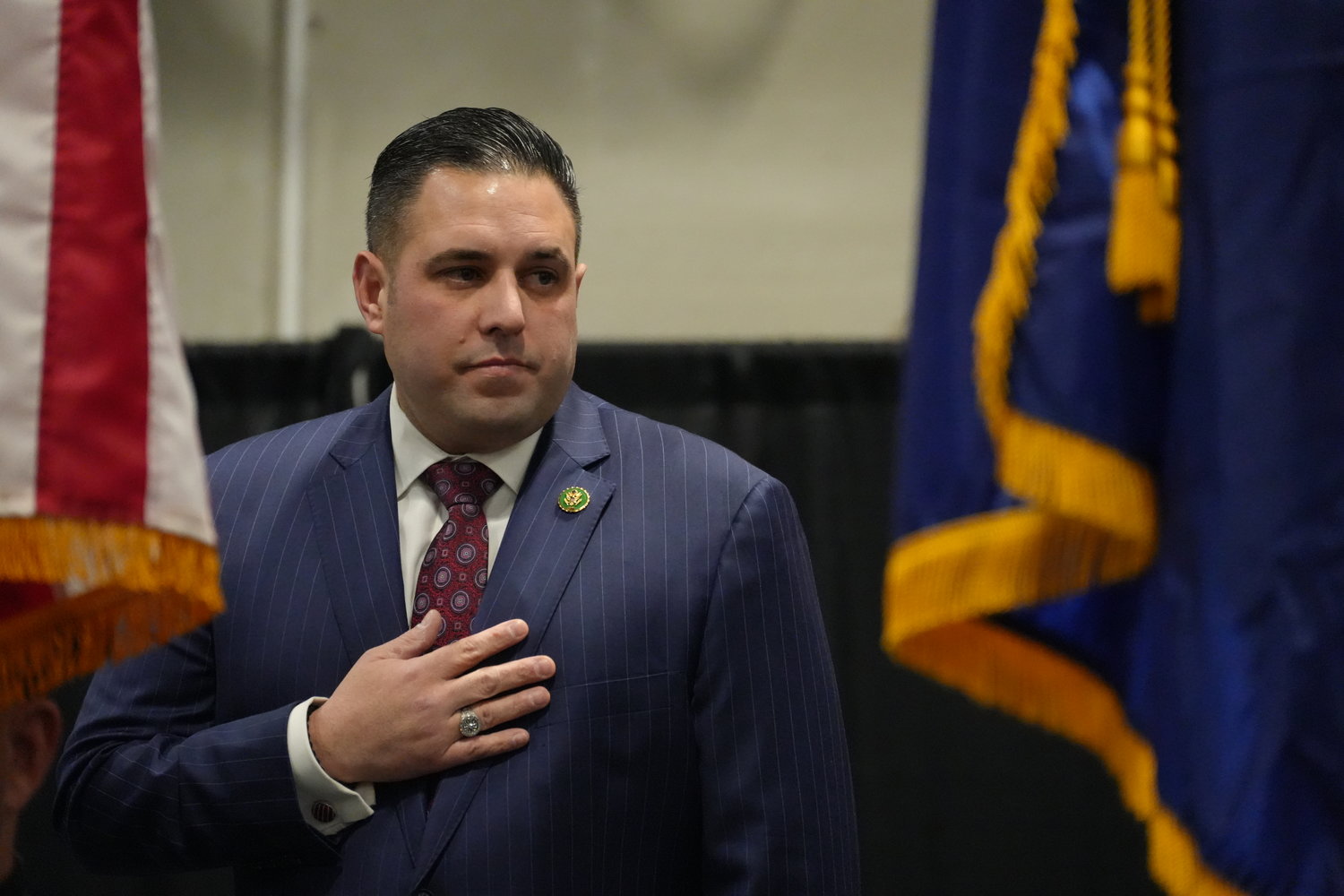 U.S. Rep. Anthony D’Esposito stands to recite the Pledge of Allegiance at his in-district swearing in ceremony at the David S. Mack Center for Training & Intelligence. D’Esposito is off to a quick start representing the 4th Congressional District, ready to try out his brand of bipartisanship in Washington.