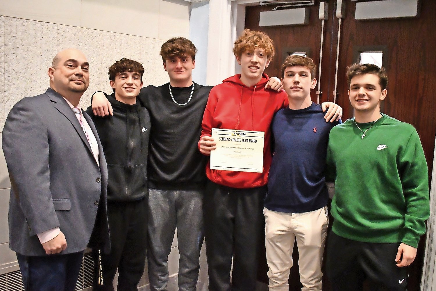Members of East Rockaway, top right, Jr./Sr. High School football were honored as a Scholar-Athlete team with Athletic Director Gary Gregory.