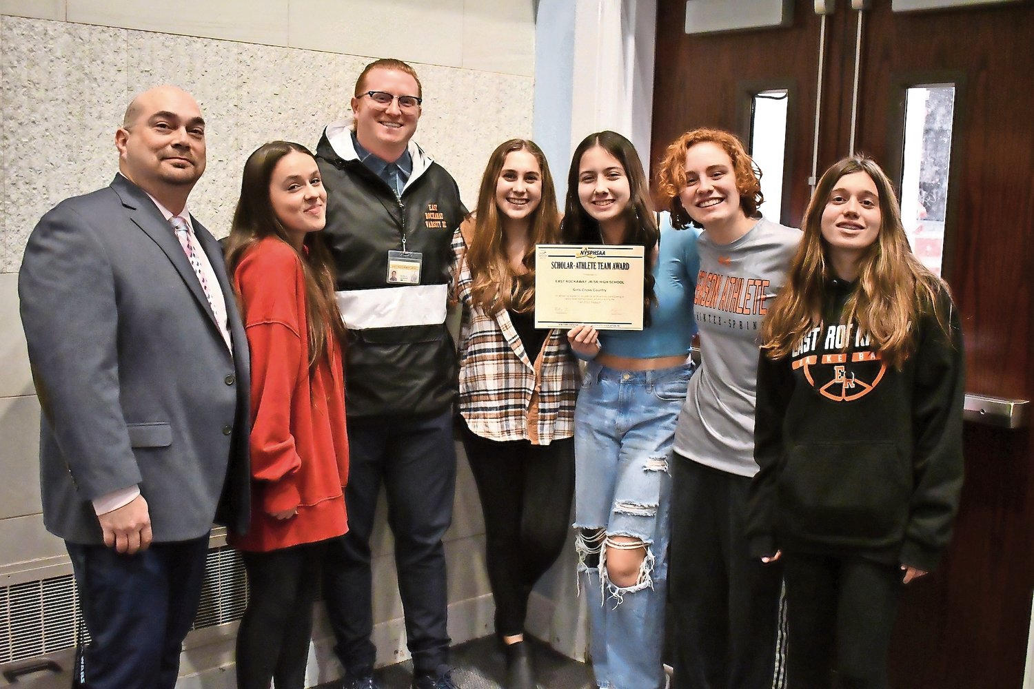 Members of East Rockaway Jr./Sr. High School girls’ cross country team were honored as a Scholar-Athlete team with Athletic Director Gary Gregory and Coach Kenneth Anderson.