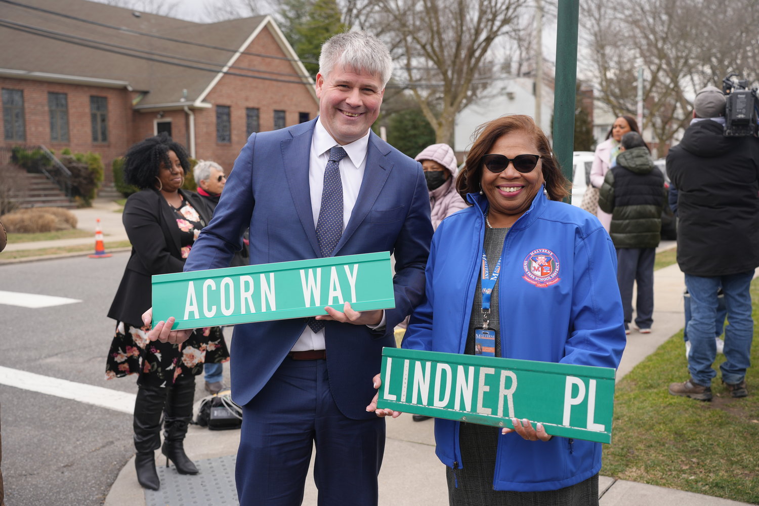 Malverne Mayor Keith Corbett and Malverne Superintendent Lorna Lewis with the present and past signs of the street.