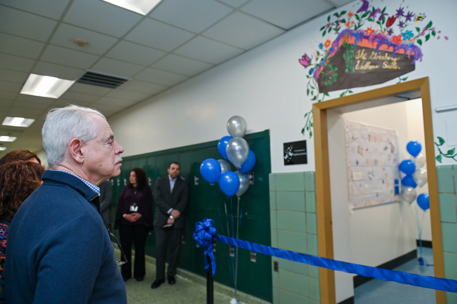Fred Yutkowitz looks into Room 107, the new wellness suite at Memorial Junior High School now dedicated in to his late wife, Stephanie Ginsberg.
