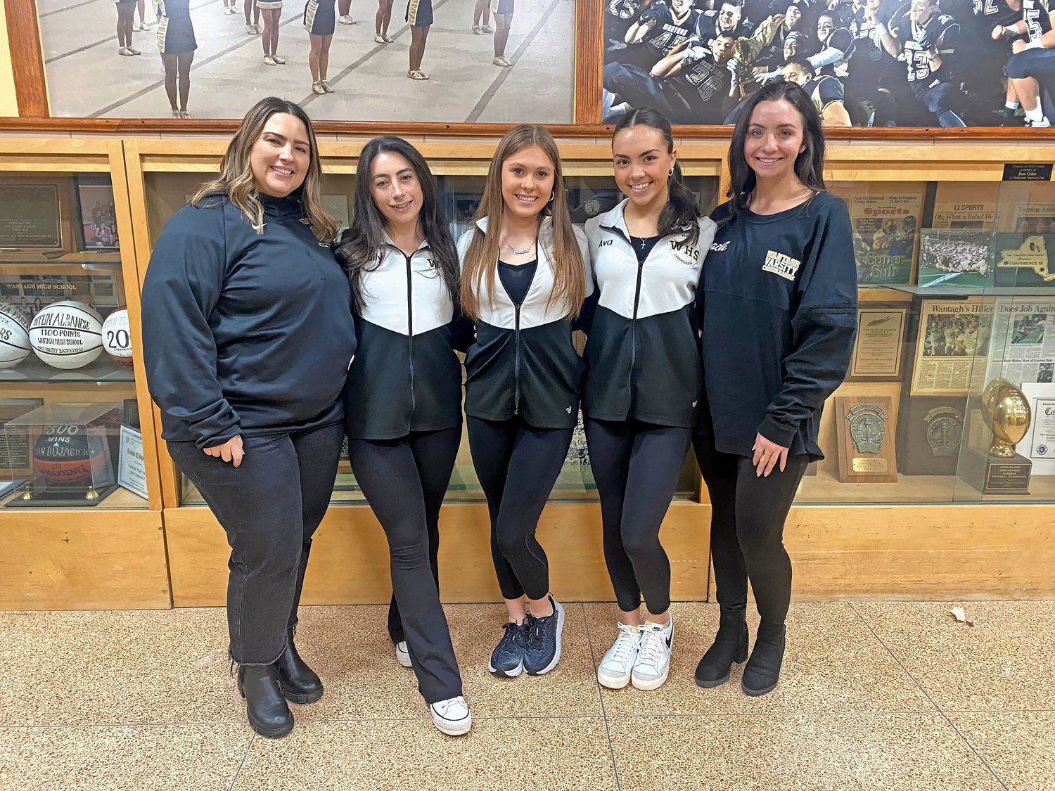 Katie Savage, far left, a Wantagh cheer coach, with senior captains Emily Drago, Jessica Balkunas and Ava Lombardo, and coach Jaclyn Bonlarron. All are heading to nationals in Florida.