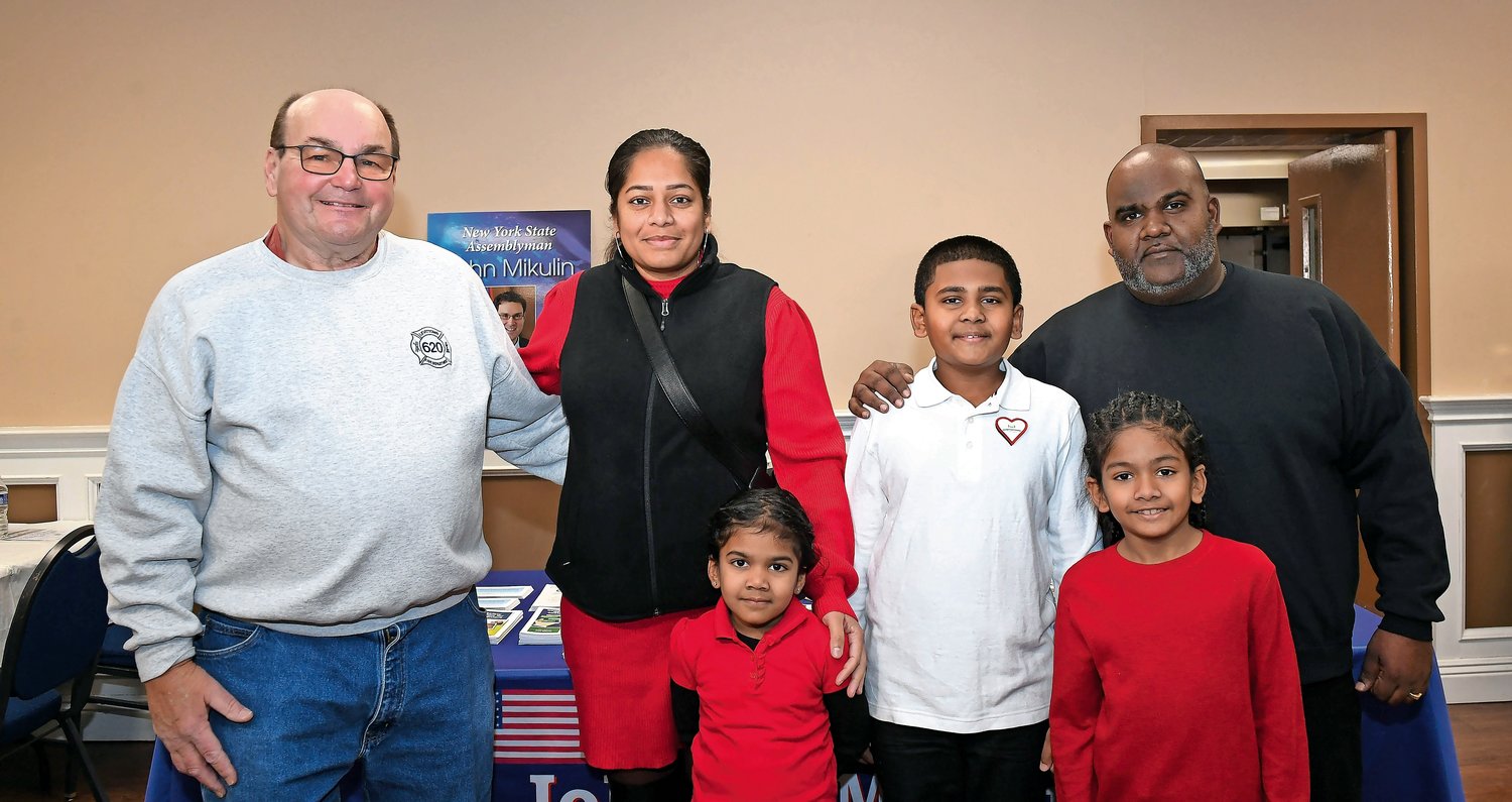 Ron Hlawaty, left, chairman of the Levittown blood drive, alongside Shamedza Singh, Faith Singh, King Singh, Mussiah Singh, and Michael Singh. Hlawaty is one of the blood donors who saved King Singh’s life