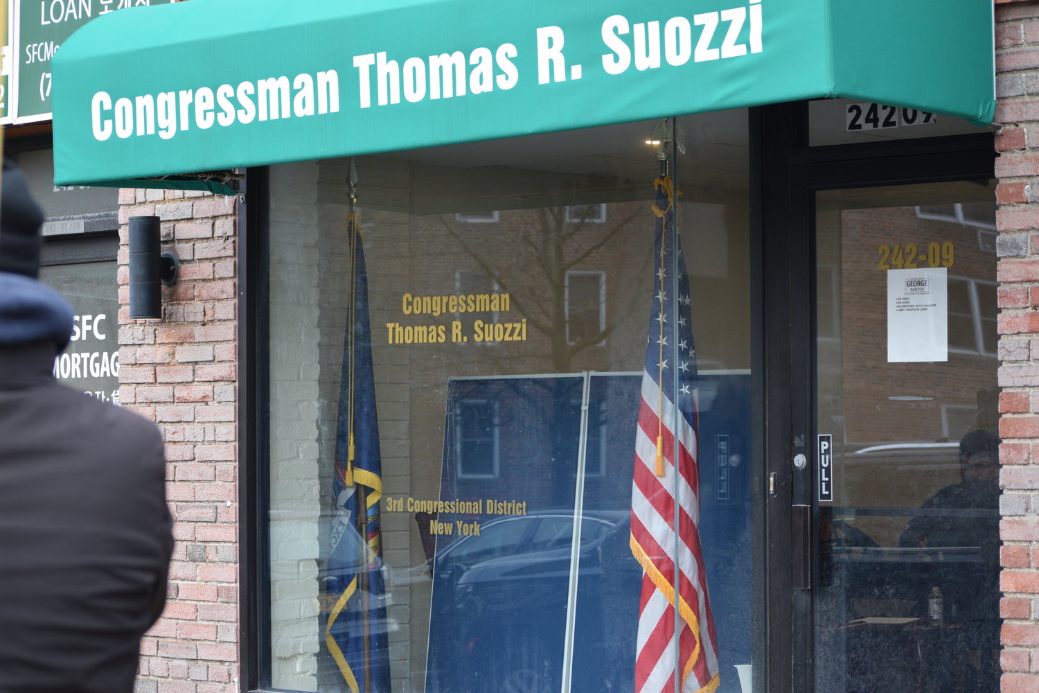 U.S. Rep. George Santos has taken over office space in the Queens neighborhood of Douglaston, but the location still bears the name of his predecessor, Tom Suozzi.