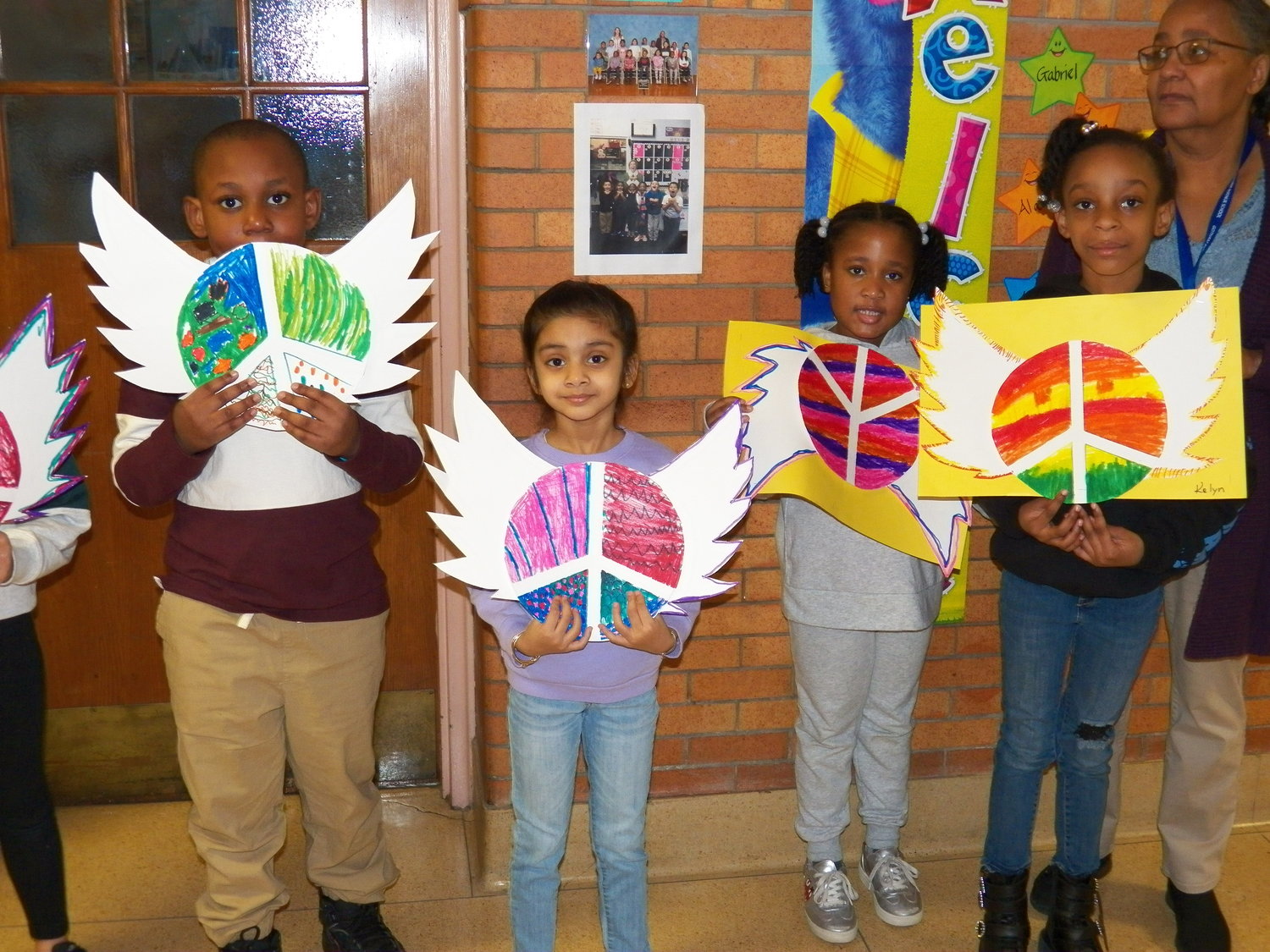 In addition to signs, the elementary students got even more creative with their decorations. This class made vibrant peace symbols with wings.