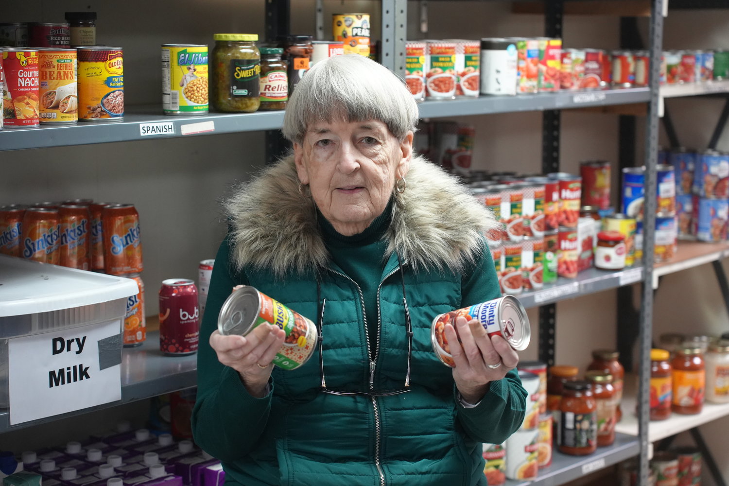 Sister Margie Kelly, the director of parish outreach at the Saint Vincent de Paul food pantry program at Holy Name of Mary Church, works with volunteers to clean and stock the pantry.