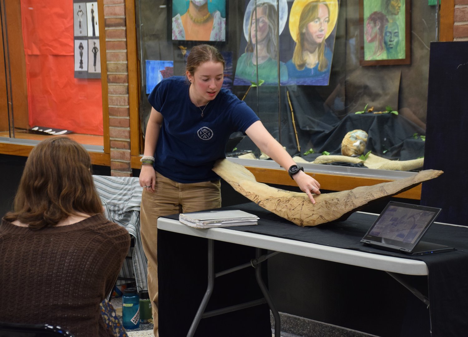 Senior Clare Simon showed interested students a wood carving project she had made for the IB Art program.