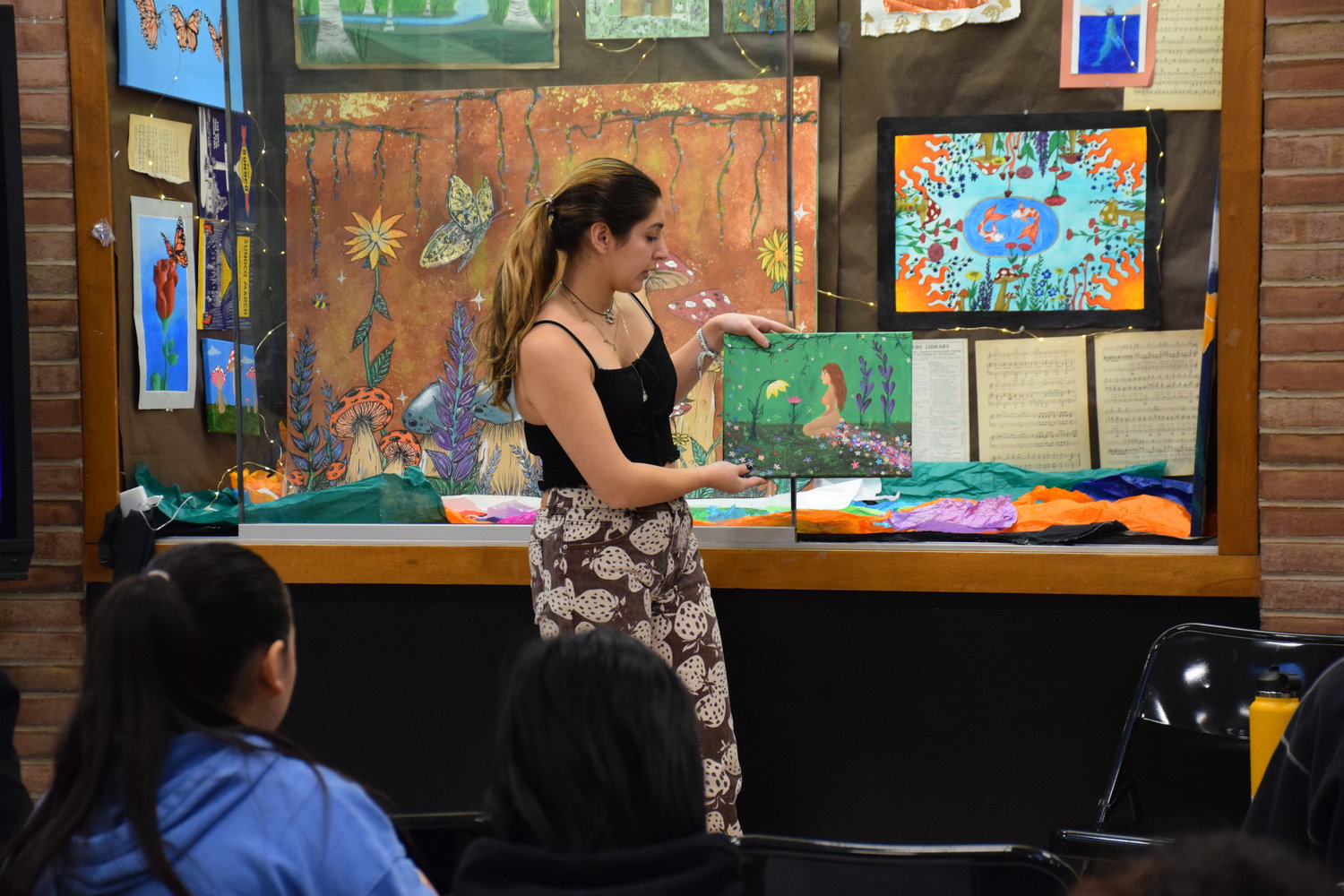 Gianna Spinelli, a senior, explained the process of how she conceptualized and made her paintings.
