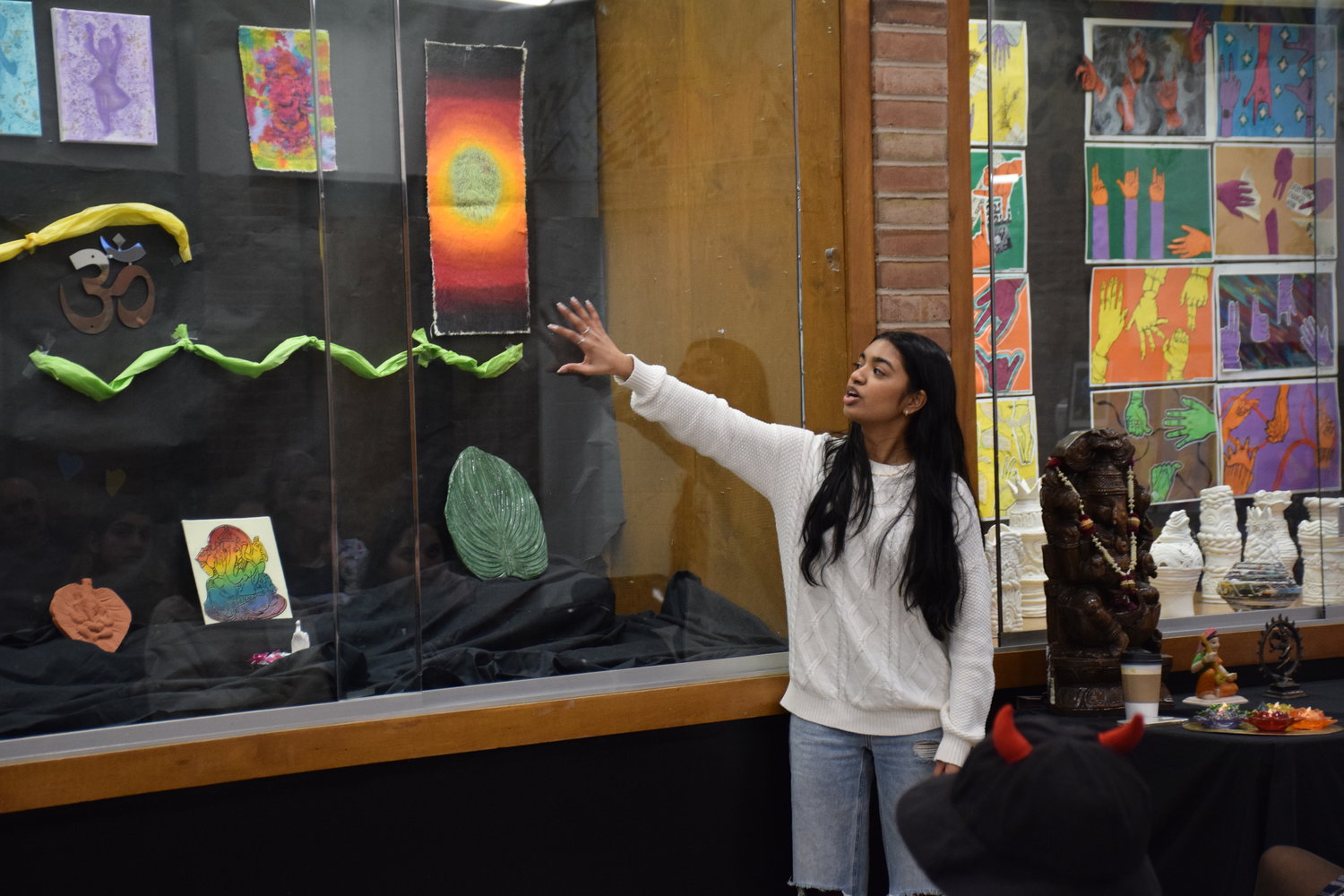 Anika Datta, another senior in the IB Art program, discussed how her artistic style was influenced by traditional depictions of the Hindu god Ganesh.