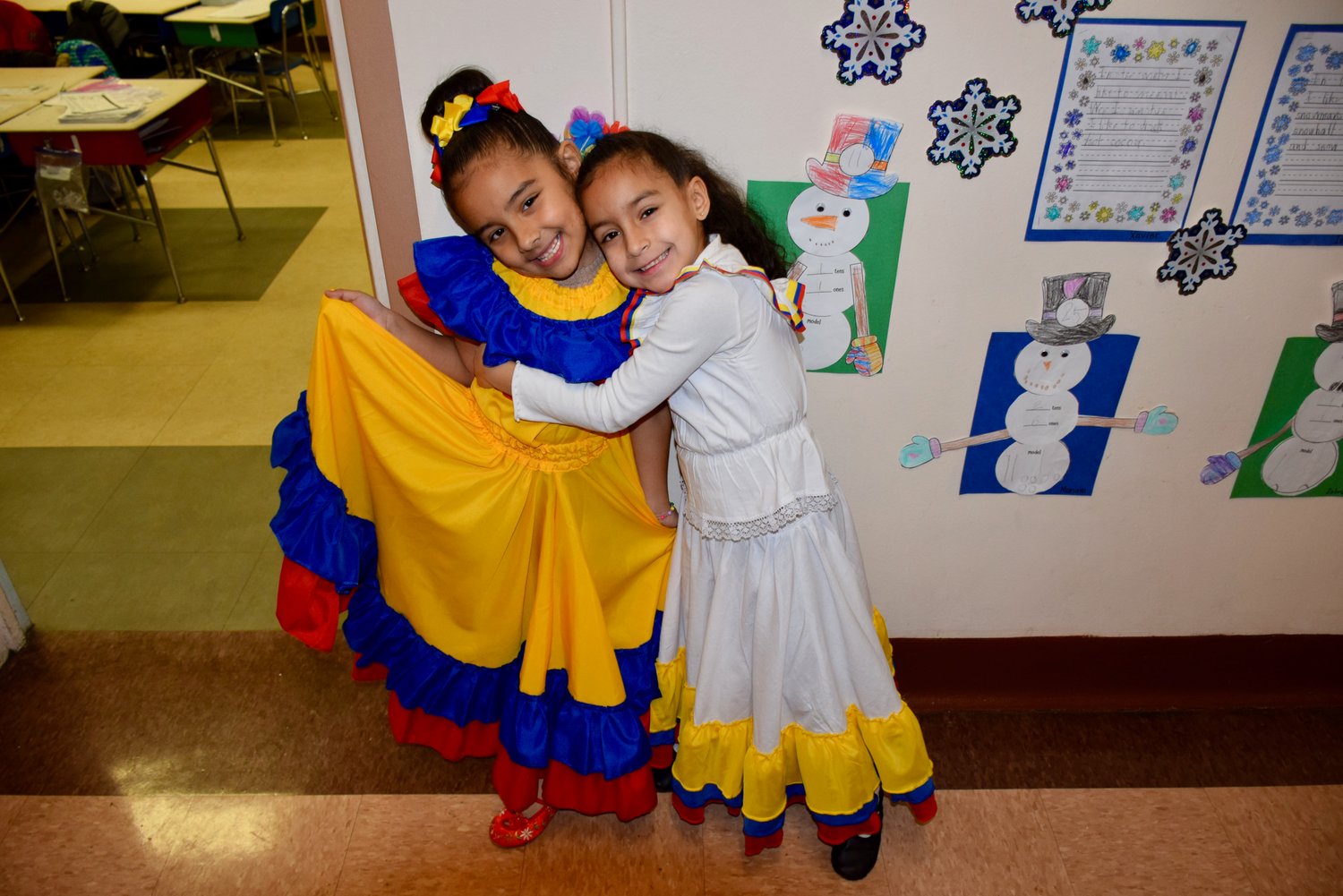 These two girls hugged it out and wore their countries’ colors with pride on Cultural Diversity Day at Covert Avenue School.