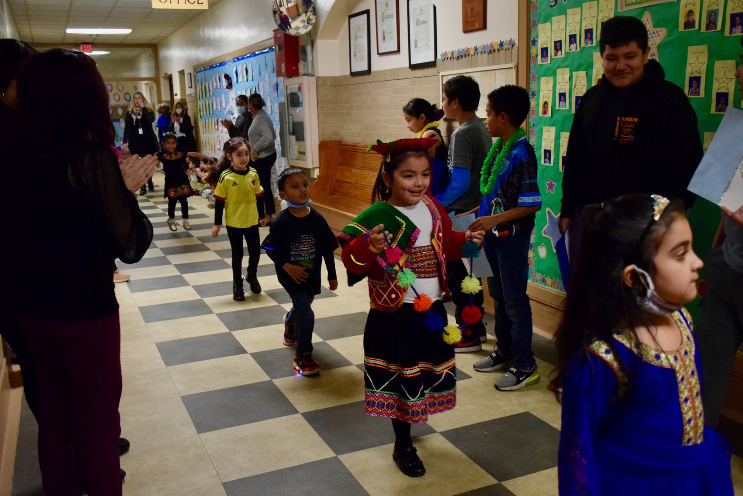 The young children marched down the hallways and received a round of applause for celebrating their cultures.