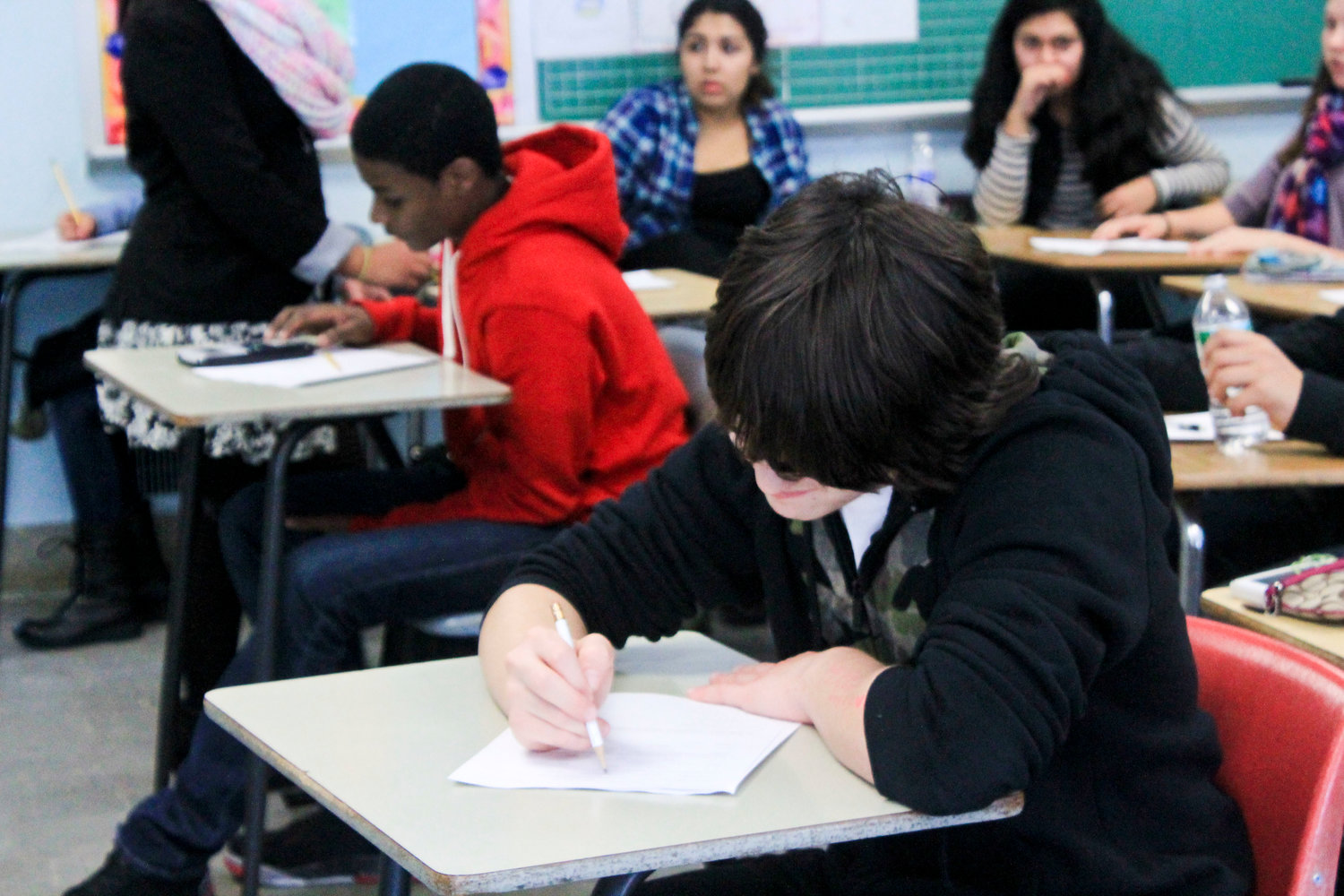 The Global History and Geography Regents is one of four exams high school students must take to earn a high school Regents diploma. The other three are math, science and English Language Arts. Above, a Lawrence High School student working on the math Regents in 2014.