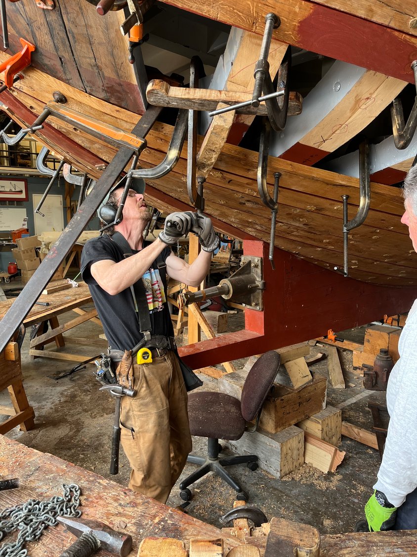 Josh Herman, the head shipwright, who has overseen the construction, is currently supervising the installation of the planks.