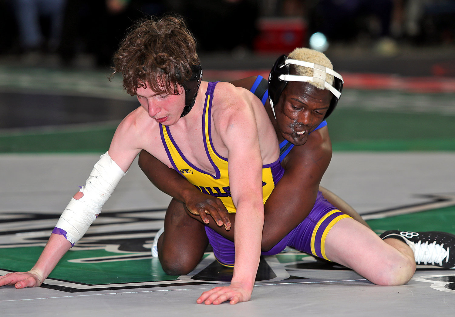 Long Beach 110-pound freshman Dunia Sibomana-Rodriguez, right, lost in the state semifinals last Saturday but battled back to gain a third-place finish.