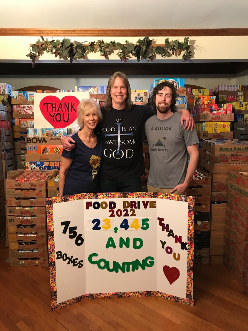 Robert Hallam, center, is organizing the 12th annual People’s Food Drive with the Long Island Council of Churches Food Pantry, to help needy South Shore families fight food insecurity. With him were his wife, Mary, and their son, Robert Hallam Jr.