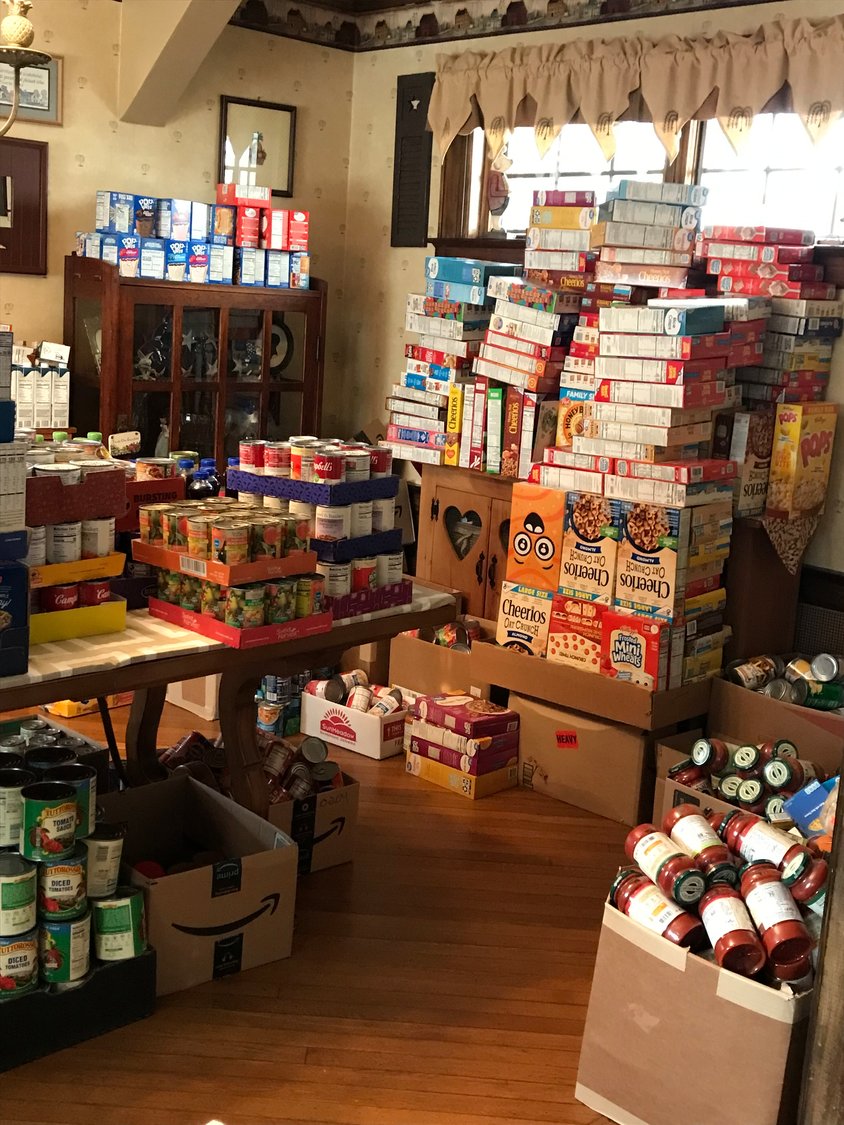 The Hallams have been collecting donated food in the living and dining rooms of their Lynbrook home, where it is divided into boxes that will be moved to the LICC pantry in Freeport later this month.