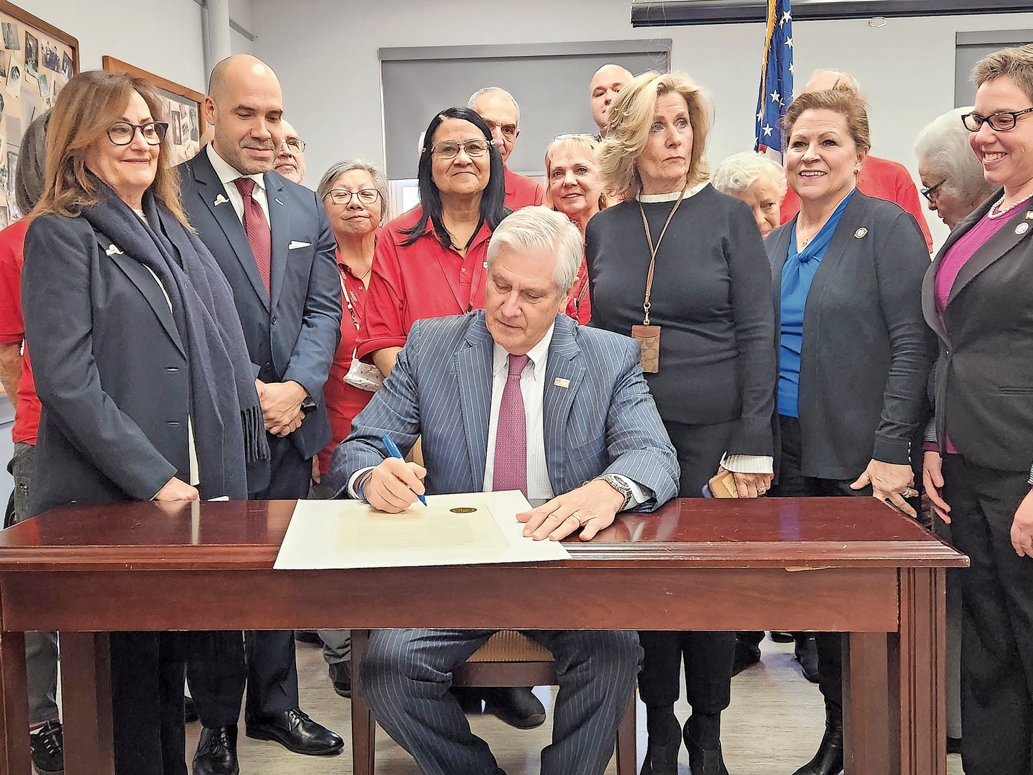 Nassau County Executive Bruce Blakeman signed a proclamation at the Glen Cove Senior Center authorizing each county department to appoint liaisons to assist senior citizens. He also helped the center obtain a fourth bus.