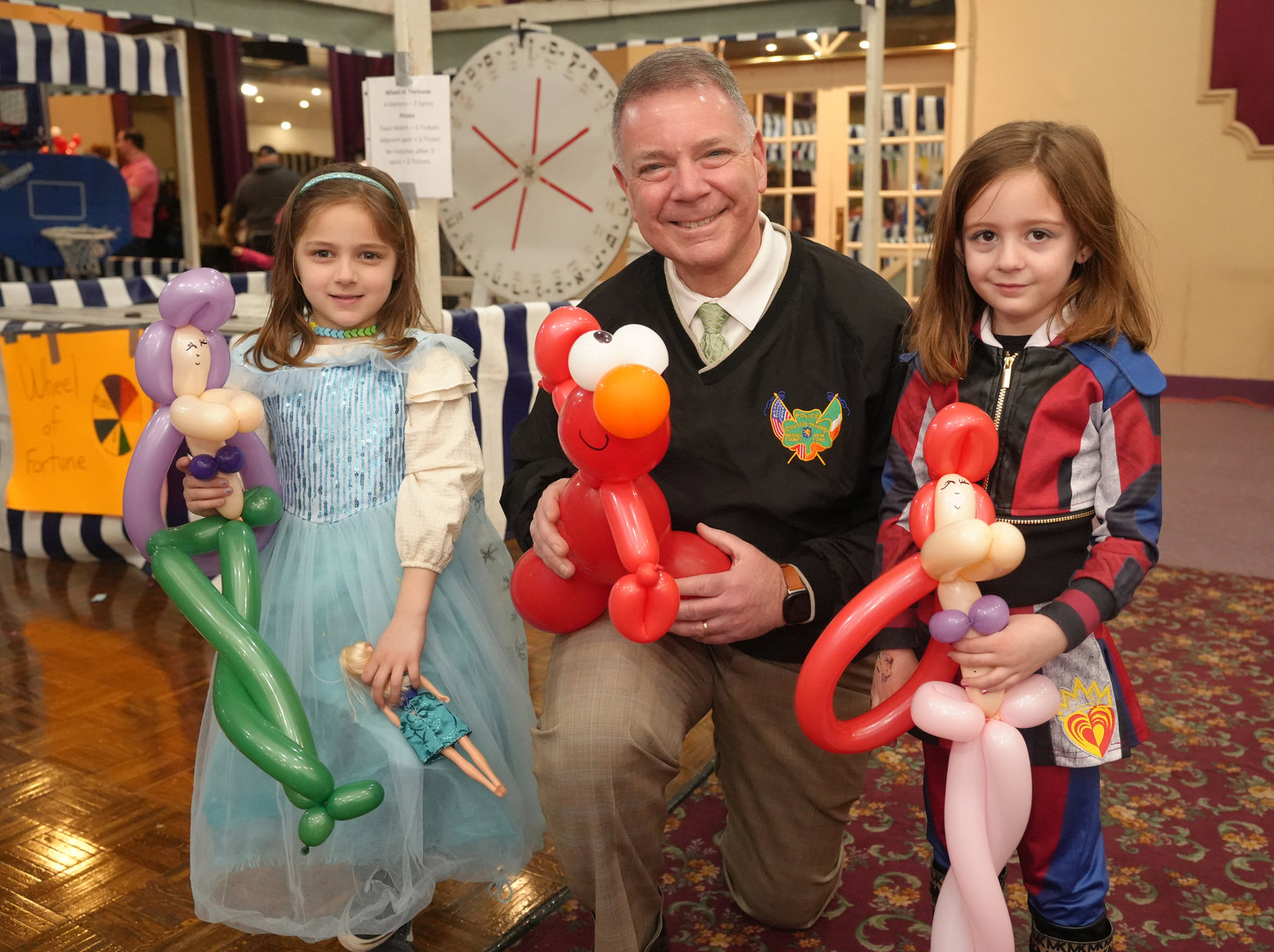 Bella Dashefsky, left, and Madison Wattel got balloon animals with State Sen. Steve Rhoads at the 28th Annual Mel Polay Purim Carnival last Sunday. Story, more photos, Page 5.