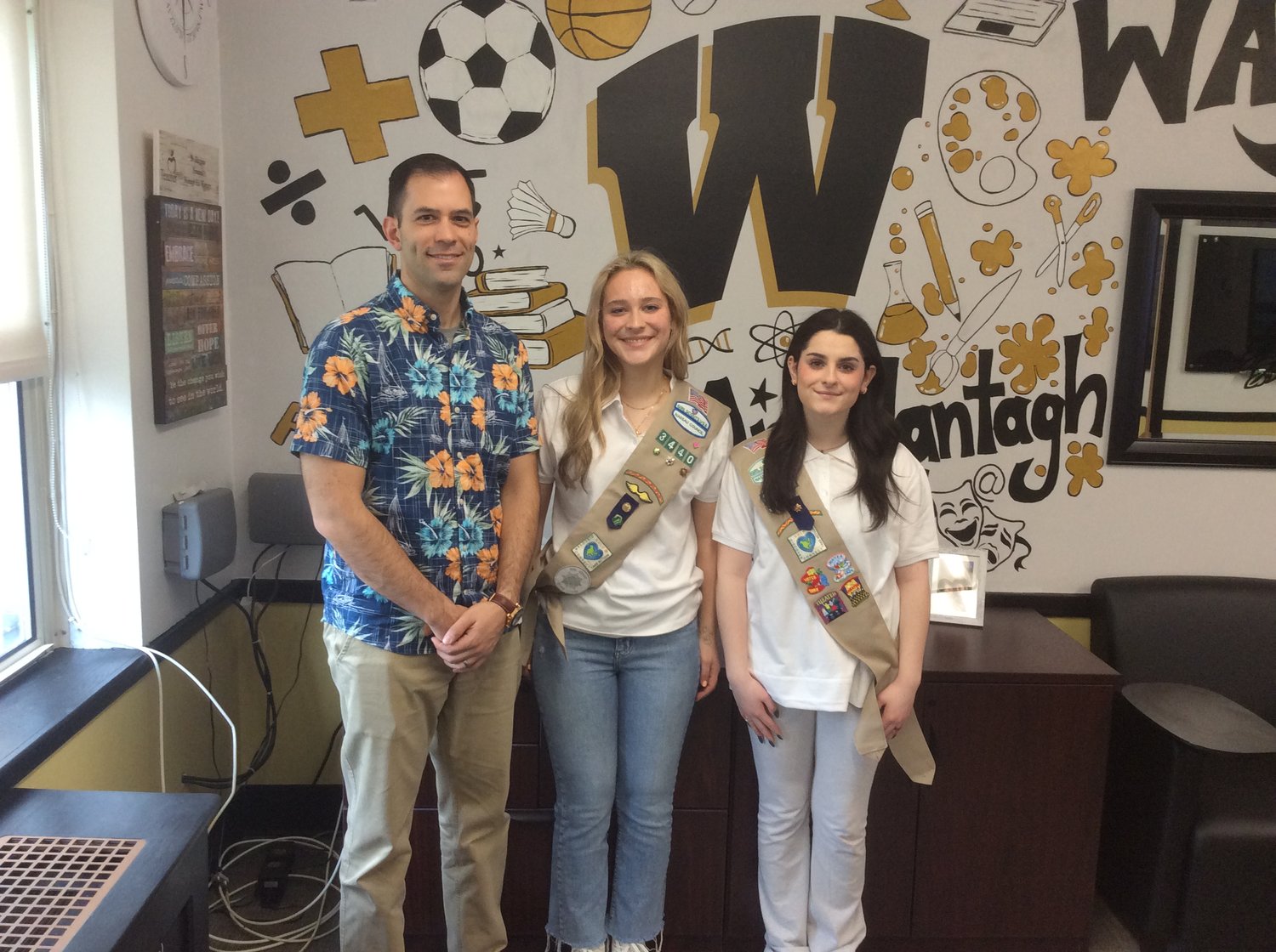 Wantagh High Principal Paul Guzzone congratulated seniors Angelina Bendetti and Nicole Tobia for receiving the Girl Scout Gold Award.
