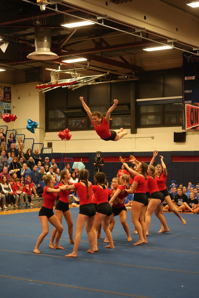 Kendall Pinsky, a South Side High School senior, soars to new heights to lead the Red team in the tumbling portion of the competition.