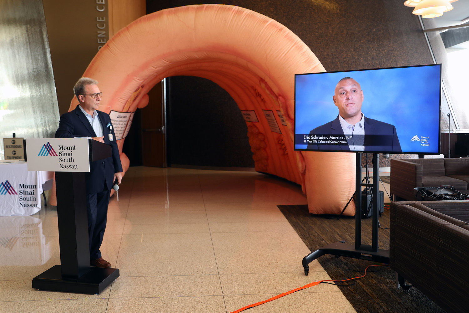Joe Calderone plays a video of Eric Schrader of Merrick, a 48-year old colorectal cancer patient who told his story of colon cancer virtually at Mount Sinai South Nassau on March 6.