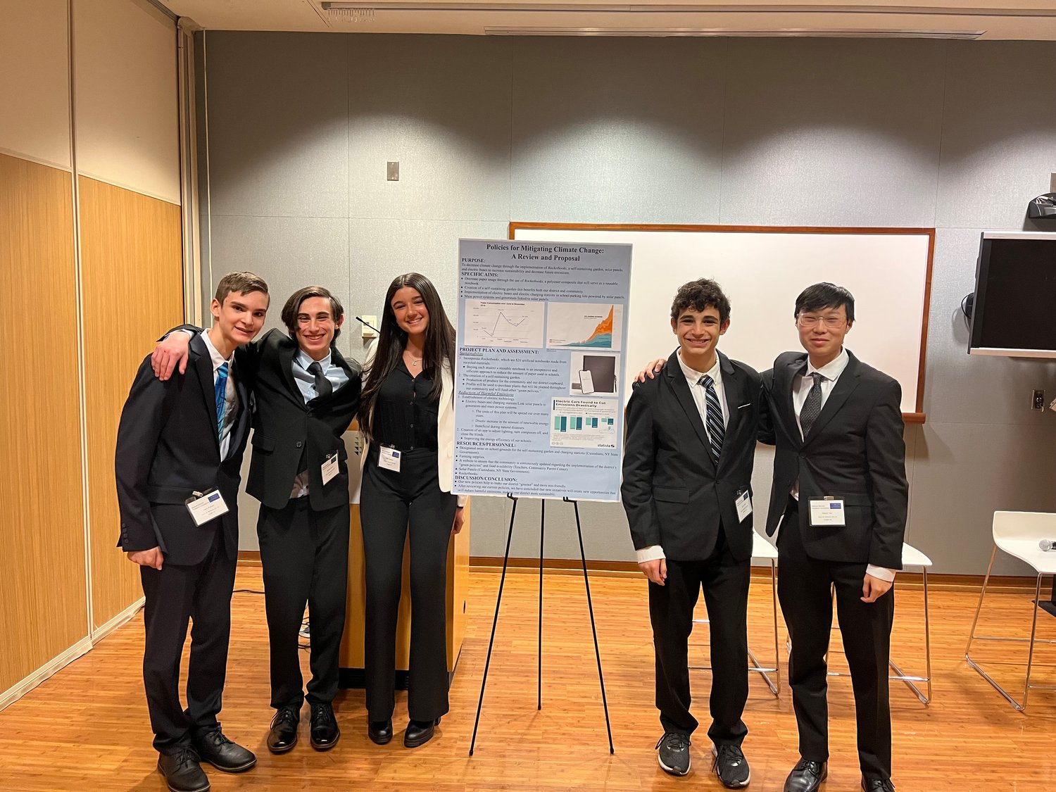 The winning team, on the day of the competition, after presenting its sustainability research on Rocketbooks — a type of reusable, eco-friendly notebook.