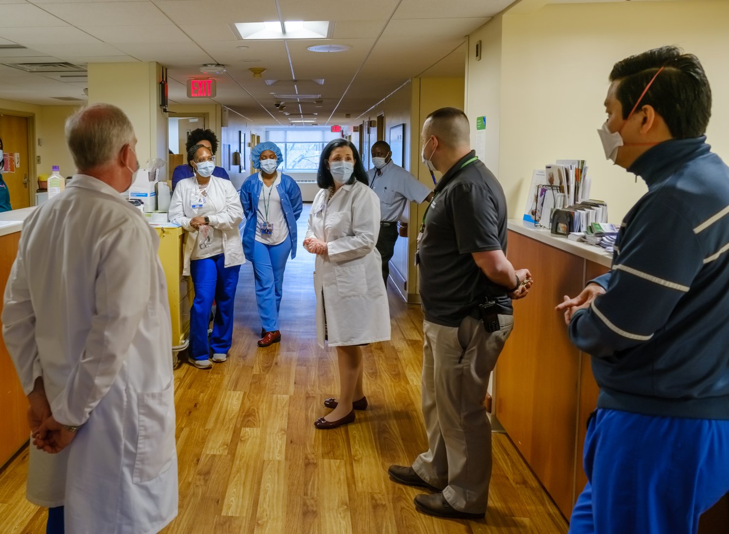 Glen Cove Hospital executive director Kerri Scanlon, center, addresses a crowd of health care professionals, working in a unit converted to treat coronavirus patients.