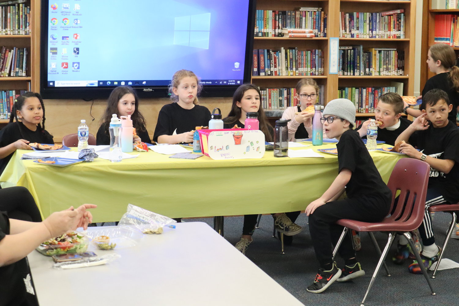 The 11 students on the committee met with Rockville Cenre school officials and members of the Education Foundation to explain how they went about encouraging participation for the incentive-based program with students at other grade levels.