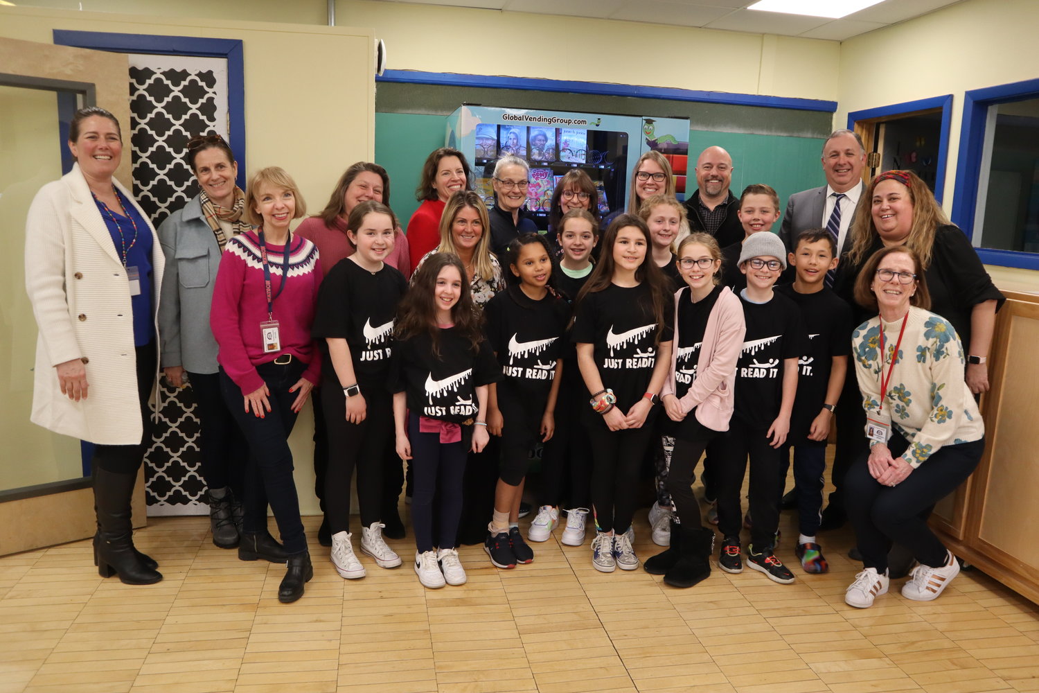 Fifth grade students Meghan Walsh, Annie Reilly, Abigail Mann, Izzy Fuentes, Ben Yin, Henry Larom, Emma Ferrari, Sophia Turk, Maggie O’Keefe, and Hudson Farish join Rockville Centre school district officials and partners with the RVC Education Foundation to present the new book vending machine, located at the back of the Watson Elementary School library.