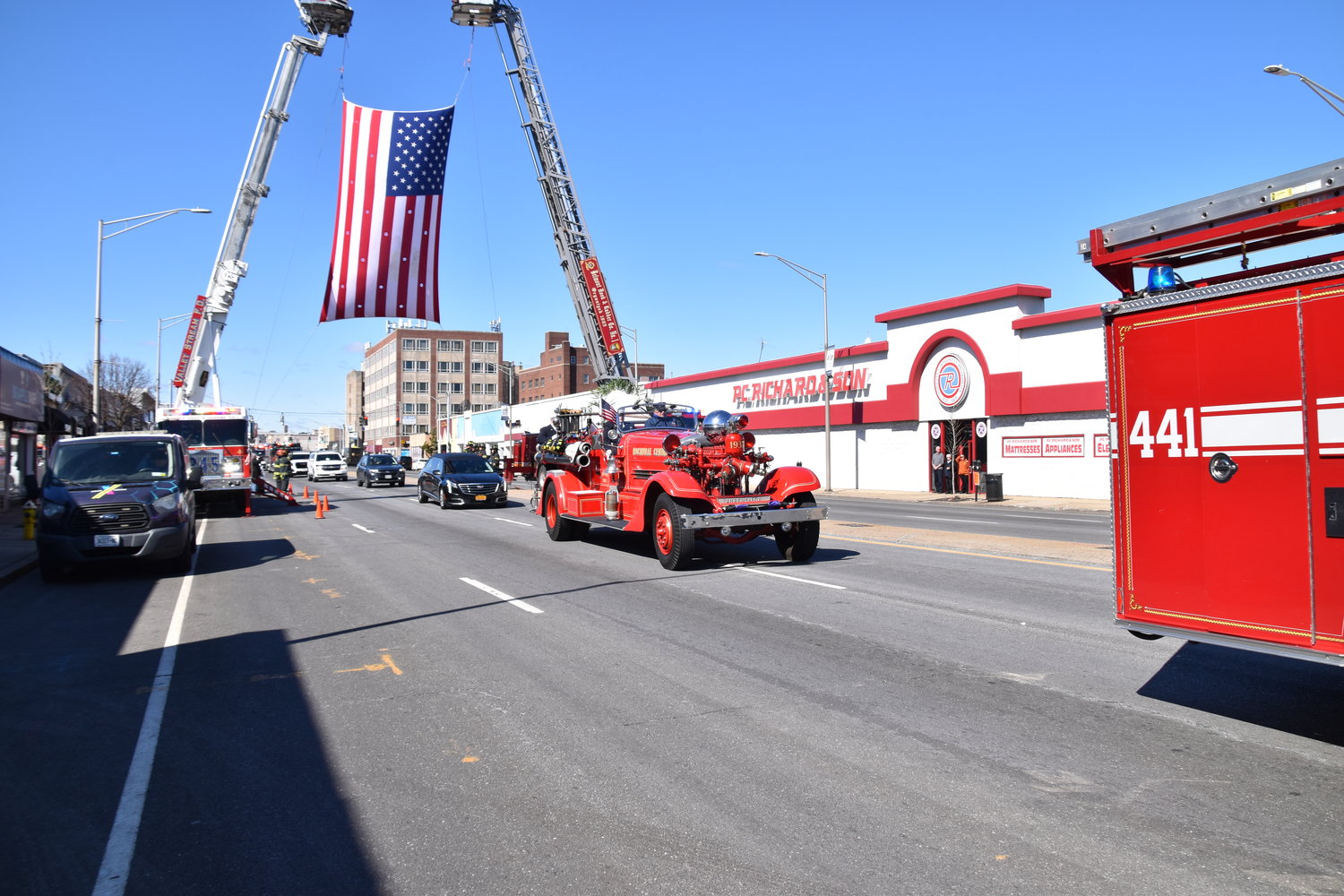 The funeral for Rockville Centre firefighter Robert ‘Bubba’ Seaman passes by P.C. Richard’s on Sunrise Highway, his former place of work.