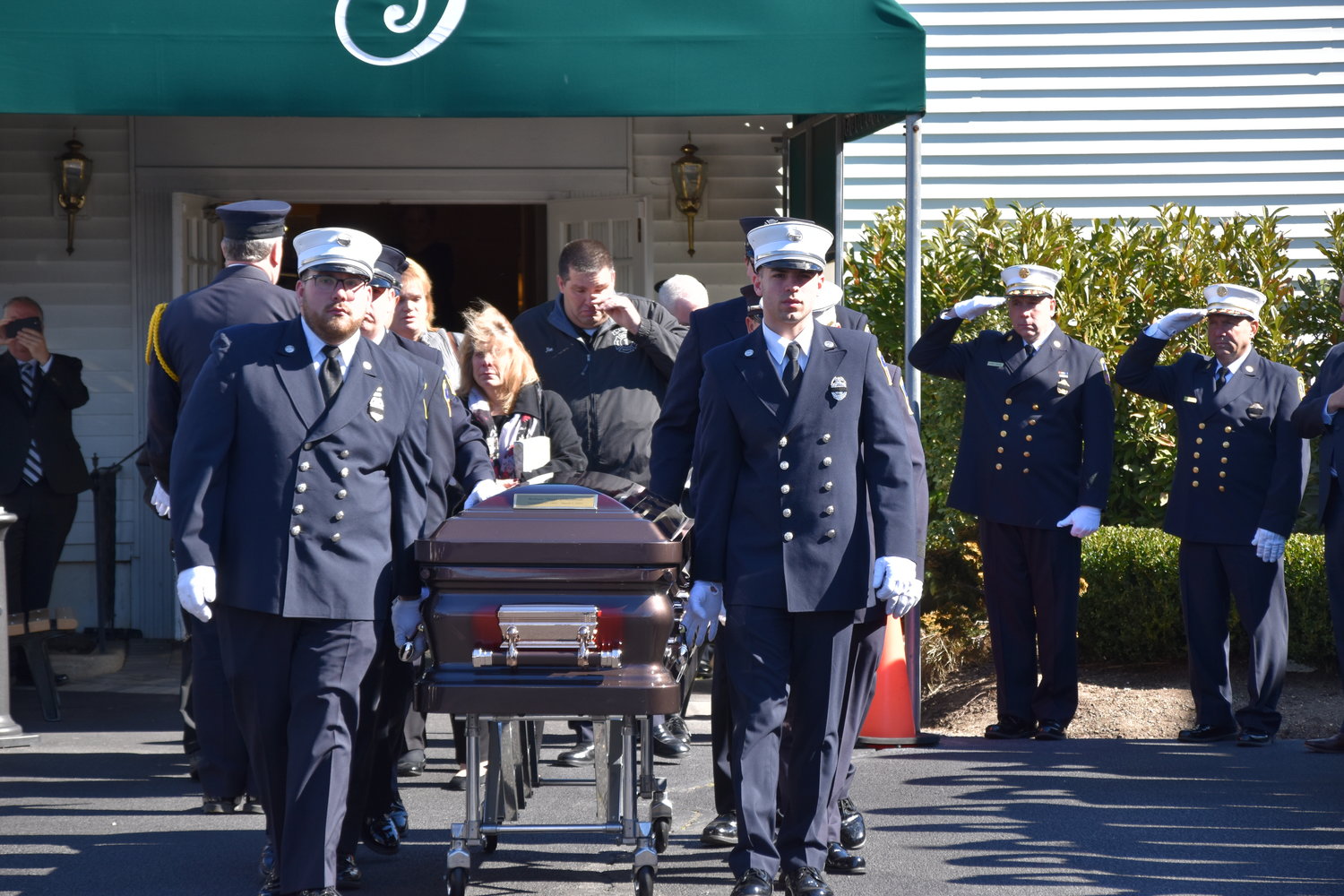 Rockville Centre Firefighters provide a proper send-off for the Ex-Chief Robert Seaman.