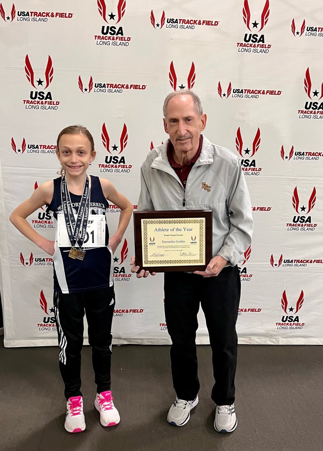 Track star Samantha Goldin with her grandfather Artie Minkoff, who was a master runner, Samantha is a third-generation runner
