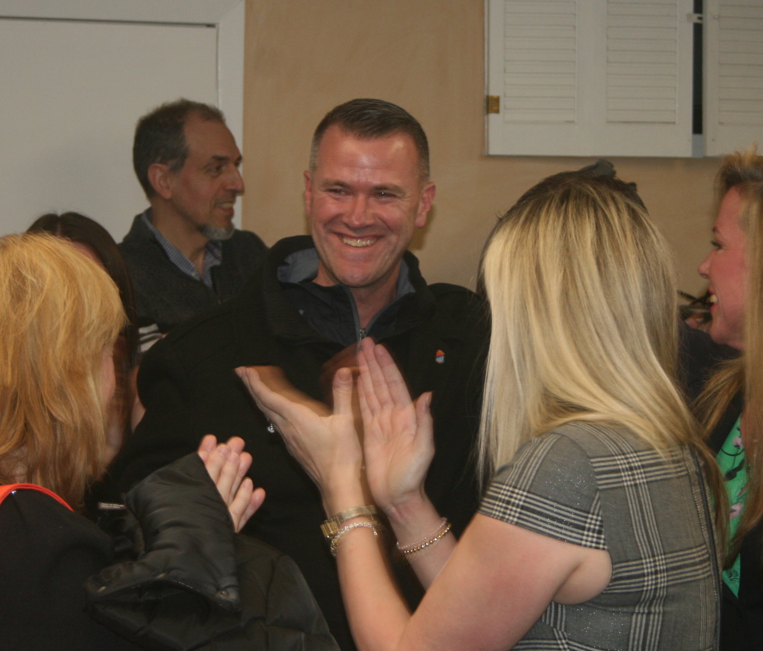 Malverne Mayor-elect Tim Sullivan celebrates as his victory is announced by elections workers Tuesday night.