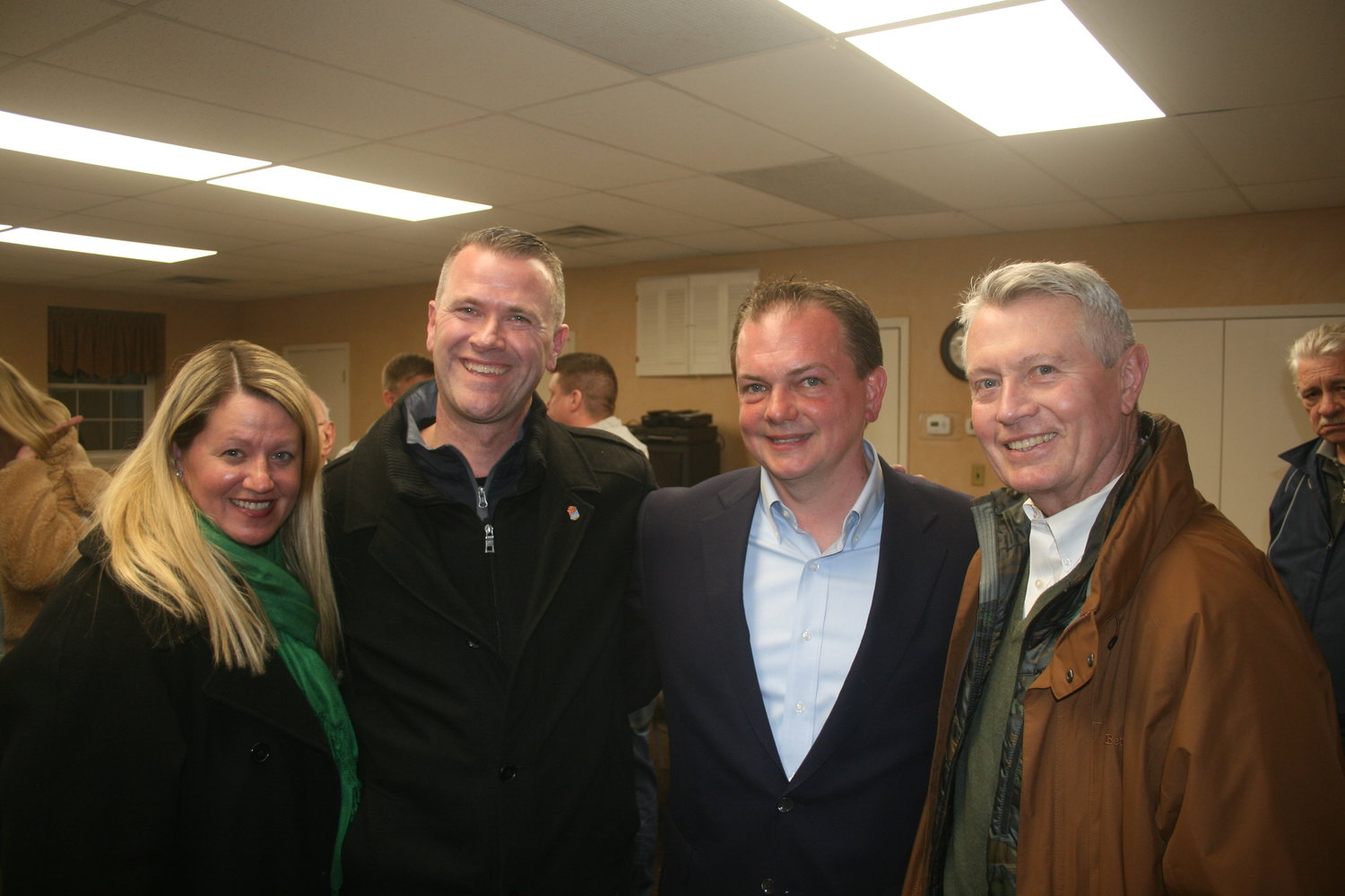 Village Trustee Lori Lang, who was appointed last month and won a special election Tuesday night, is joined by Mayor-elect Tim Sullivan, left, Trustee-elect Scott Edwards and Village Justice Jim Frankie.